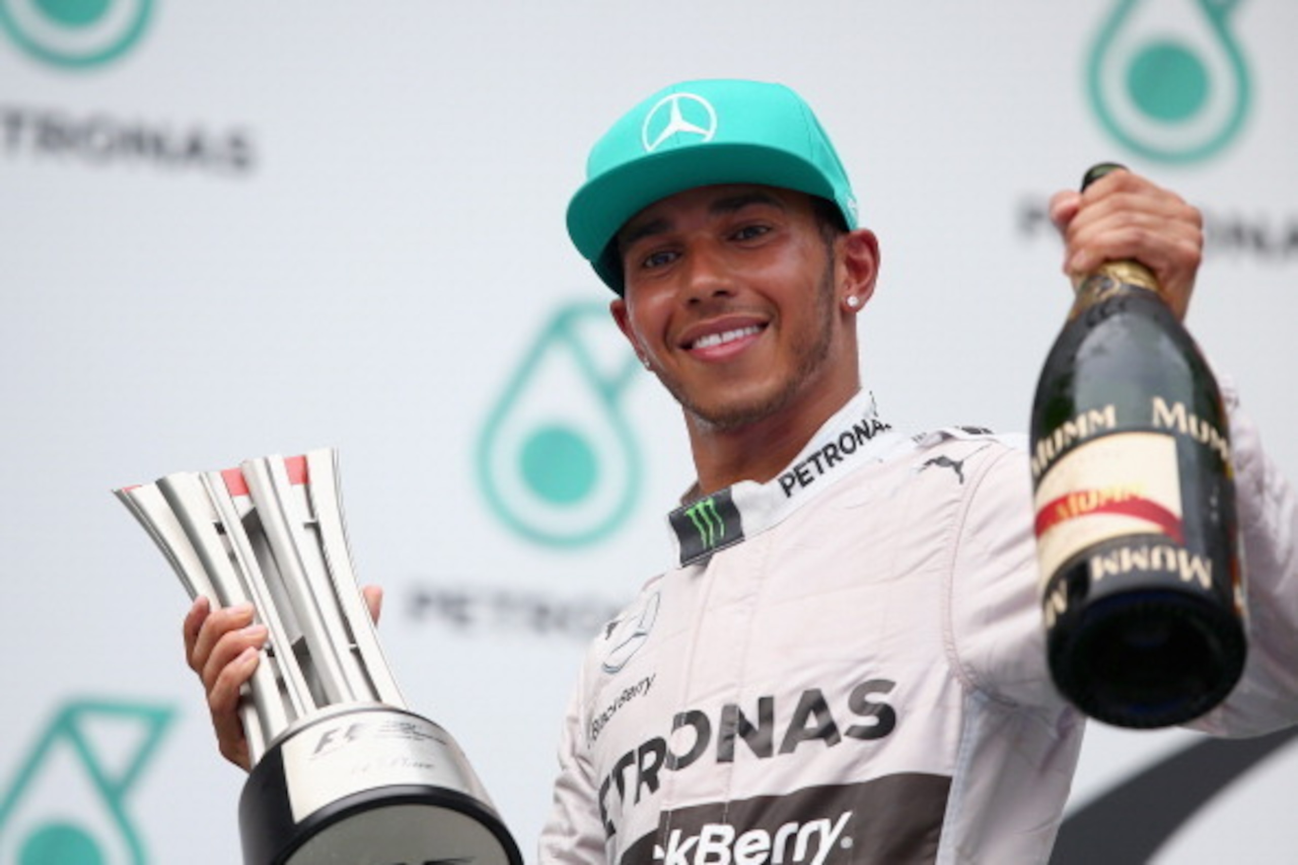 KUALA LUMPUR, MALAYSIA - MARCH 30:  Race winner Lewis Hamilton of Great Britain and Mercedes GP celebrates on the podium after the Malaysia Formula One Grand Prix at the Sepang Circuit on March 30, 2014 in Kuala Lumpur, Malaysia.  (Photo by Clive Mason/Ge