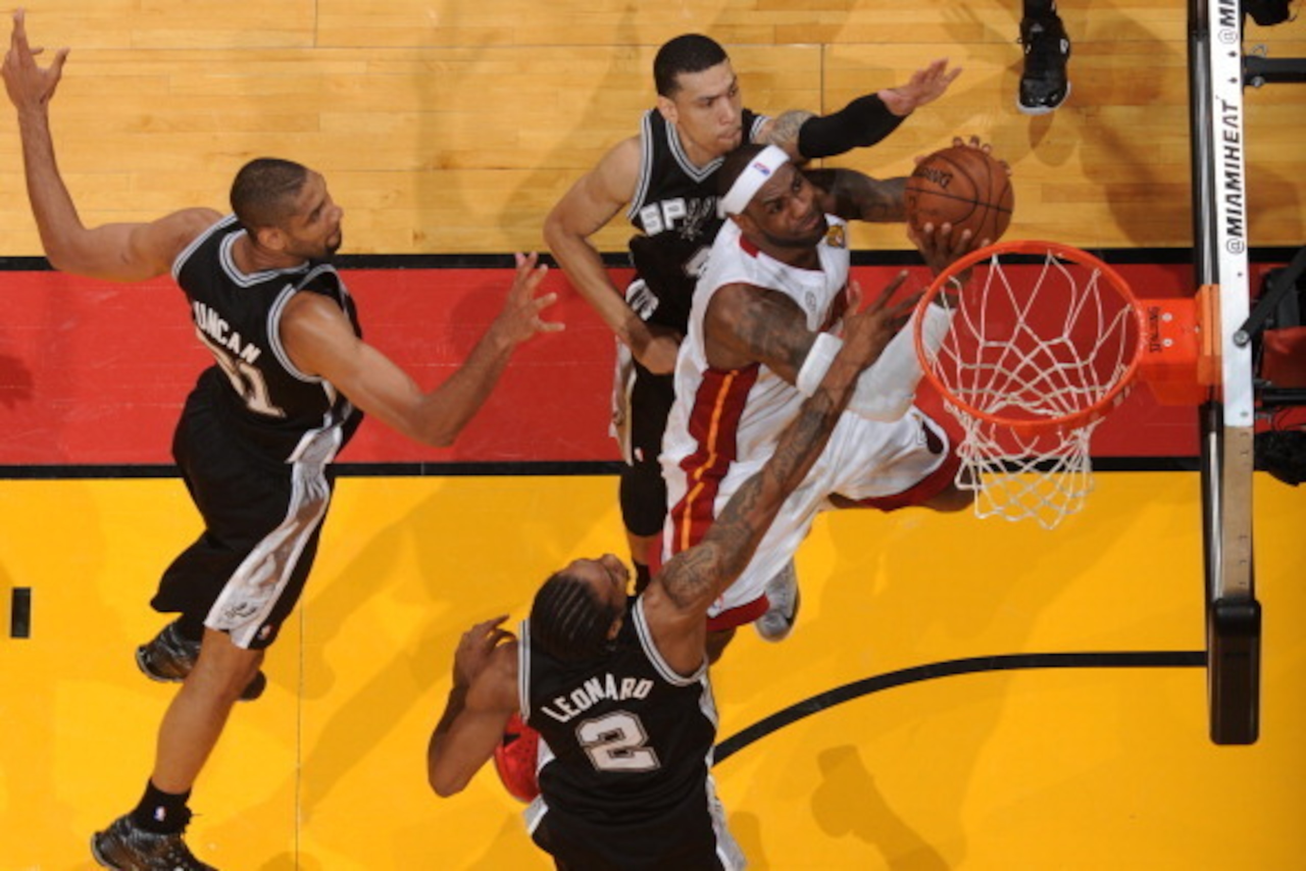 MIAMI, FL - JUNE 18: LeBron James #6 of the Miami Heat attempts a shot against Kawhi Leonard #2 and Danny Green #4 of the San Antonio Spurs during Game Six of the 2013 NBA Finals on June 18, 2013 at the American Airlines Arena in Miami, Florida. NOTE TO U