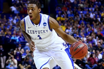 ST LOUIS, MO - MARCH 21: James Young #1 of the Kentucky Wildcats drives to the basket as Marcus Foster #2 of the Kansas State Wildcats defends during the second round of the 2014 NCAA Men's Basketball Tournament at the Scottrade Center on March 21, 2014 i