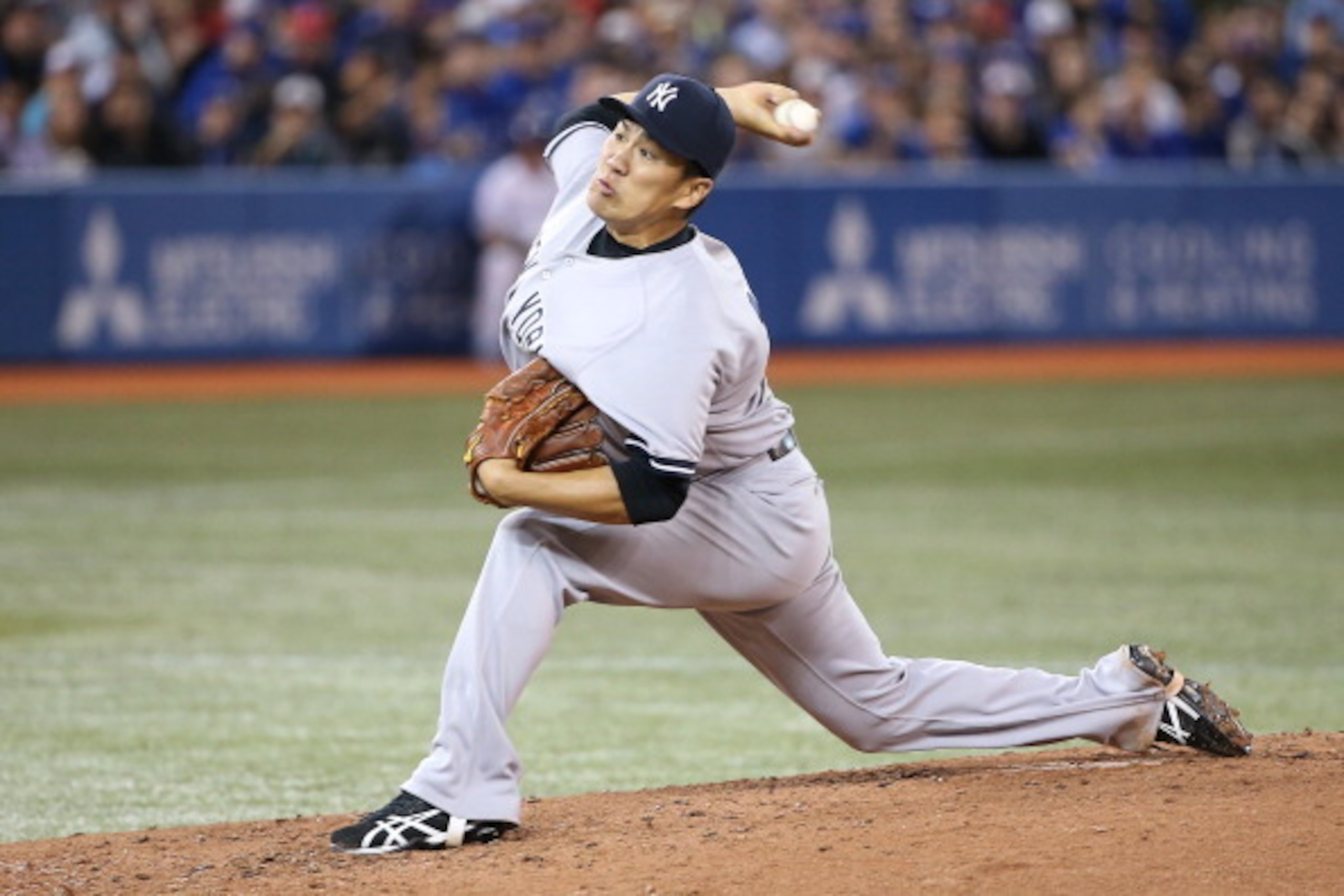 TORONTO, CANADA - APRIL 4: Masahiro Tanaka #19 of the New York Yankees delivers a pitch in the second inning during MLB game action against the Toronto Blue Jays on April 4, 2014 at Rogers Centre in Toronto, Ontario, Canada. (Photo by Tom Szczerbowski/Get