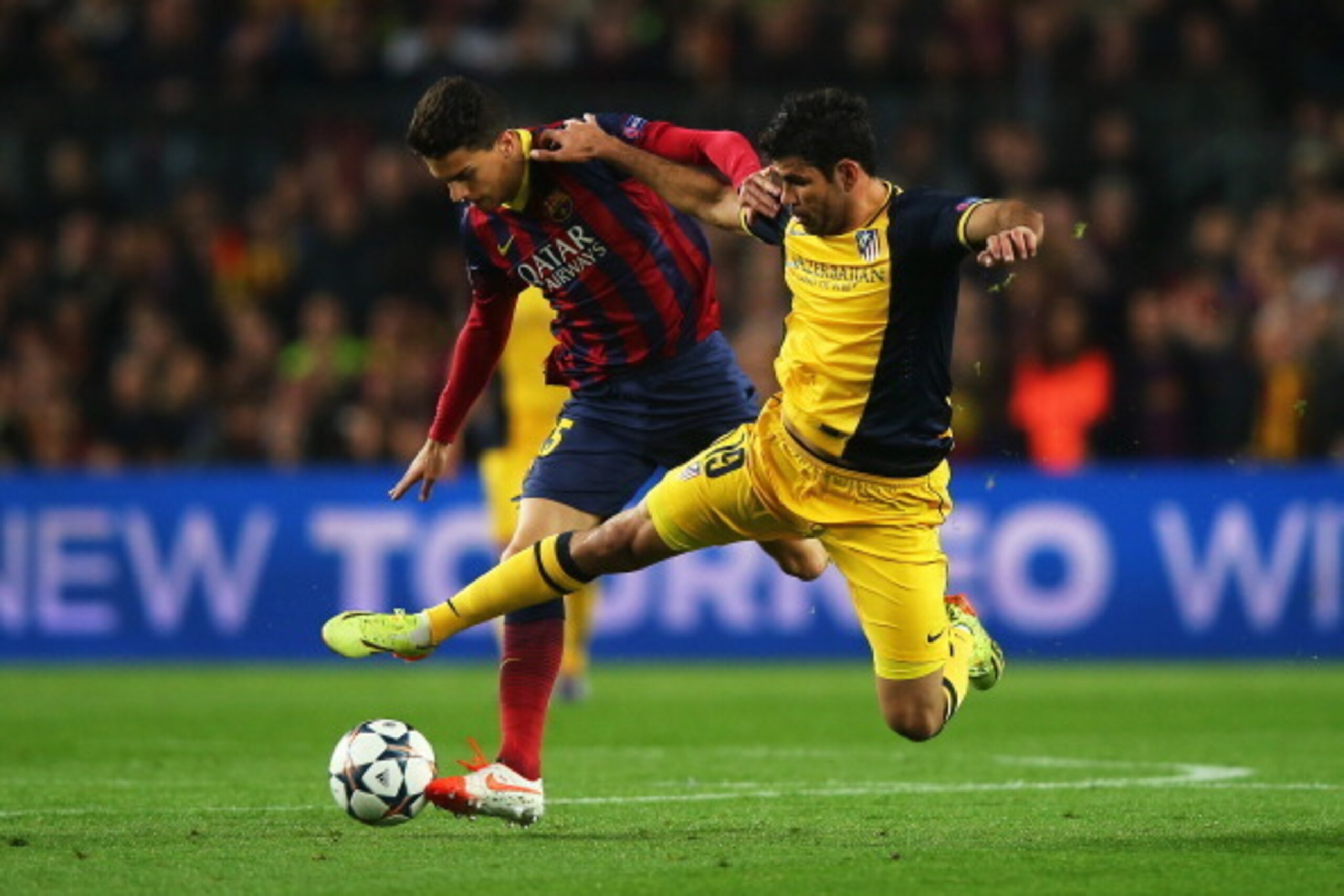 BARCELONA, SPAIN - APRIL 01:  Diego Costa of Club Atletico de Madrid challenges Marc Bartra of Barcelona during the UEFA Champions League Quarter Final first leg match between FC Barcelona and Club Atletico de Madrid at Camp Nou on April 1, 2014 in Barcel