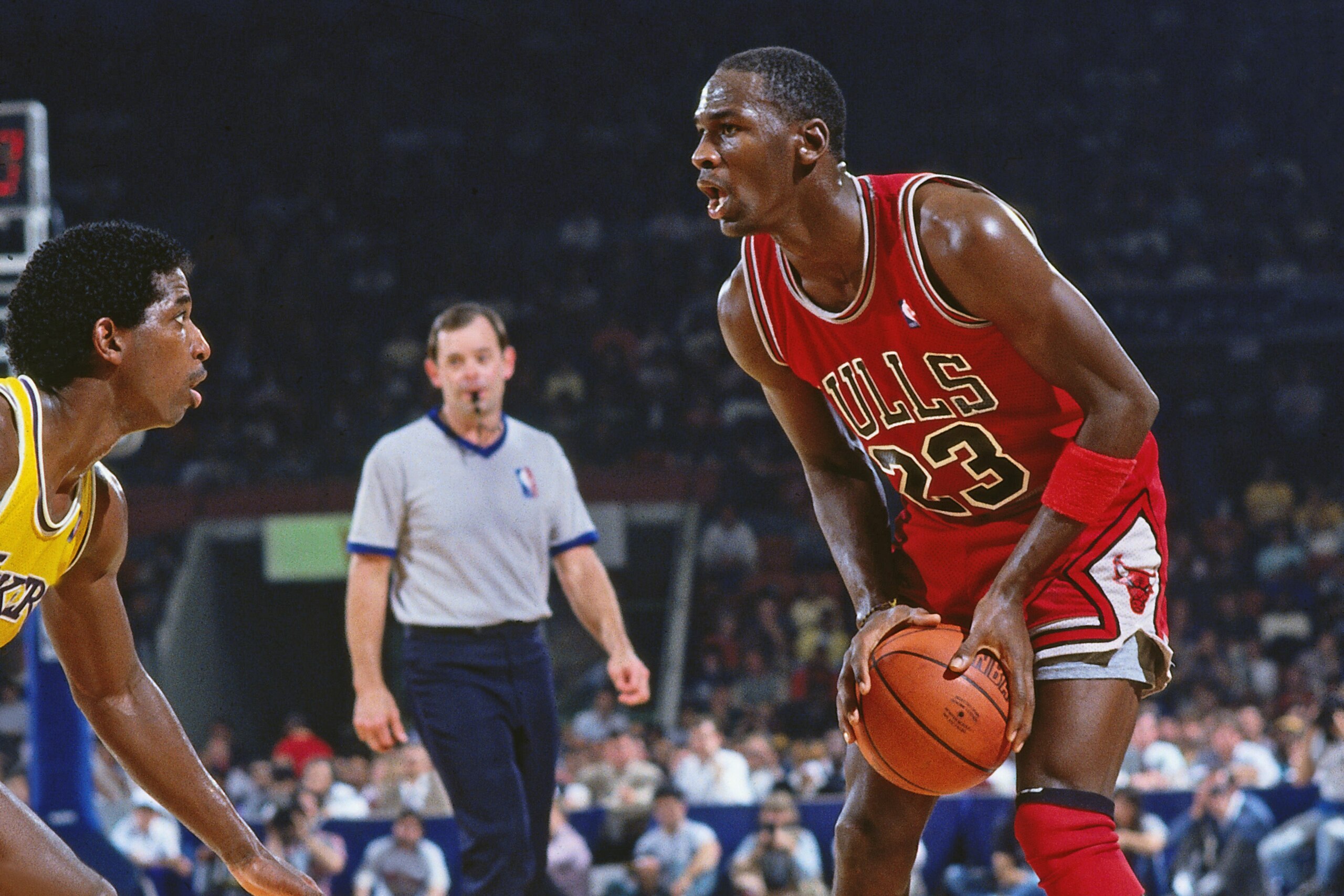 INGLEWOOD, CA - CIRCA 1987: Michael Jordan #23 of the Chicago Bulls drives against A.C. Green #45 of the Chicago Bulls circa 1987 at the Great Western Forum in Inglewood, California. NOTE TO USER: User expressly acknowledges and agrees that, by downloadin