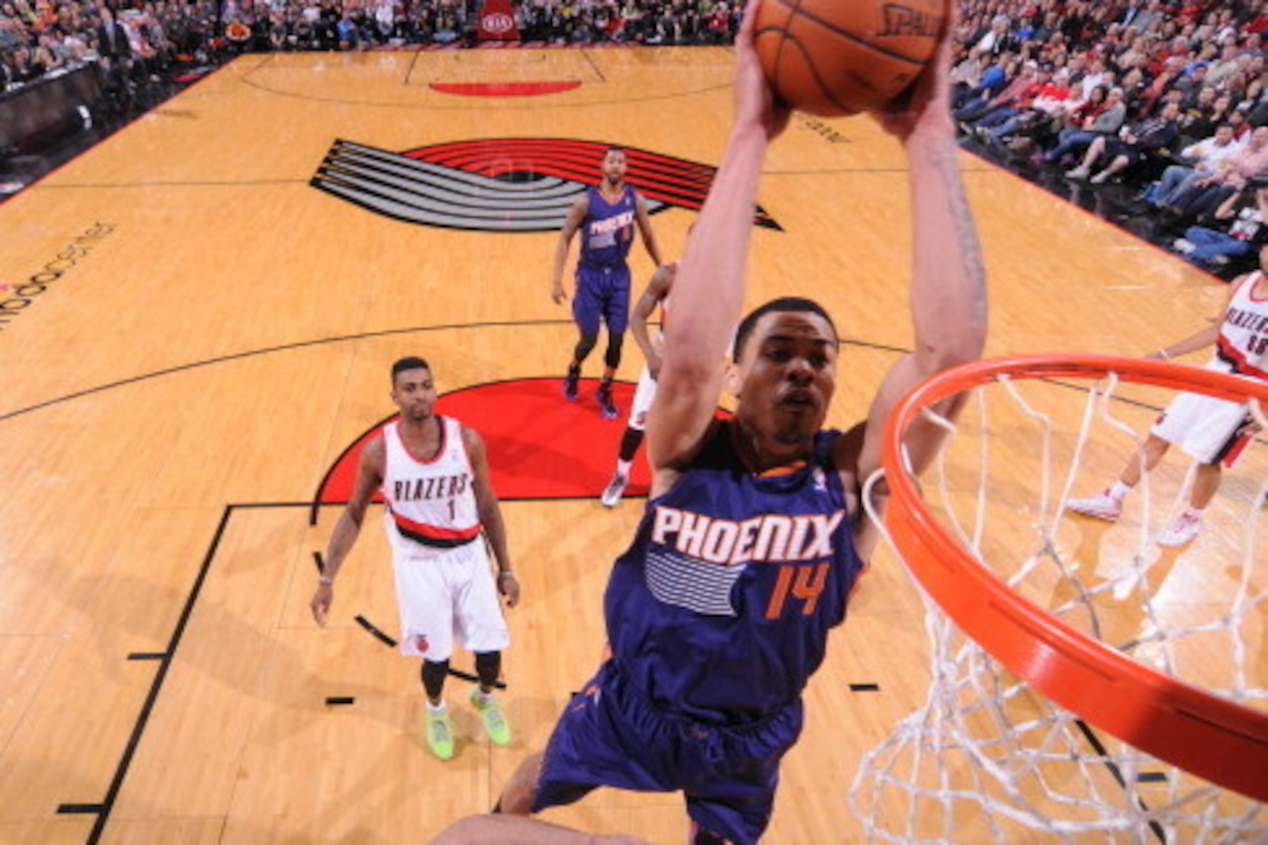 PORTLAND, OR - APRIL 4: Gerald Green #14 of the Phoenix Suns dunks against the Portland Trail Blazers on April 4, 2014 at the Moda Center Arena in Portland, Oregon. NOTE TO USER: User expressly acknowledges and agrees that, by downloading and or using thi