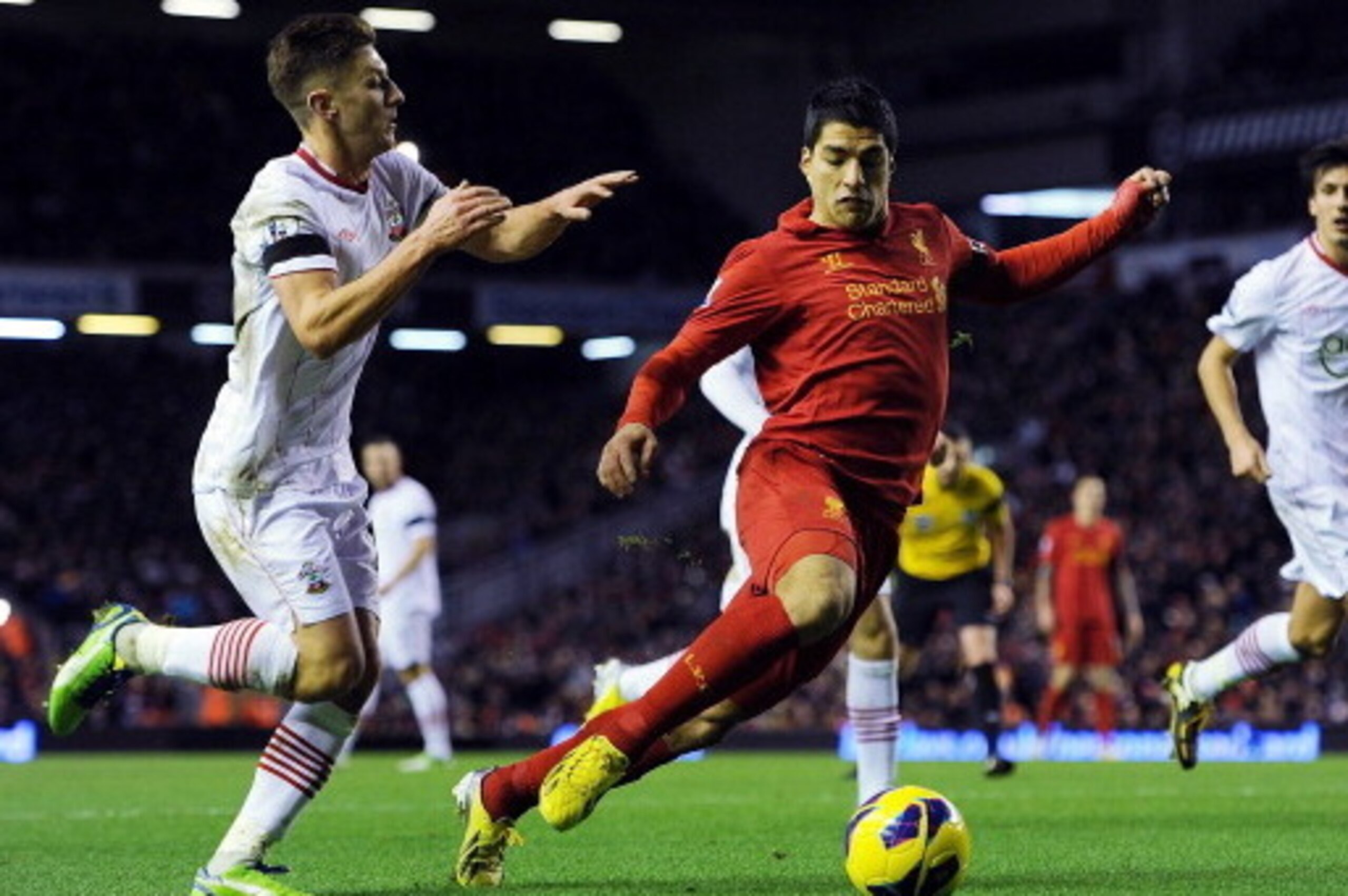 LIVERPOOL, ENGLAND - DECEMBER 01:  Luis Suarez of Liverpool in action with Adam Lallana of Southampton during the Barclays Premier League match between Liverpool and Southampton at Anfield on December 1, 2012 in Liverpool, England.  (Photo by Chris Brunsk