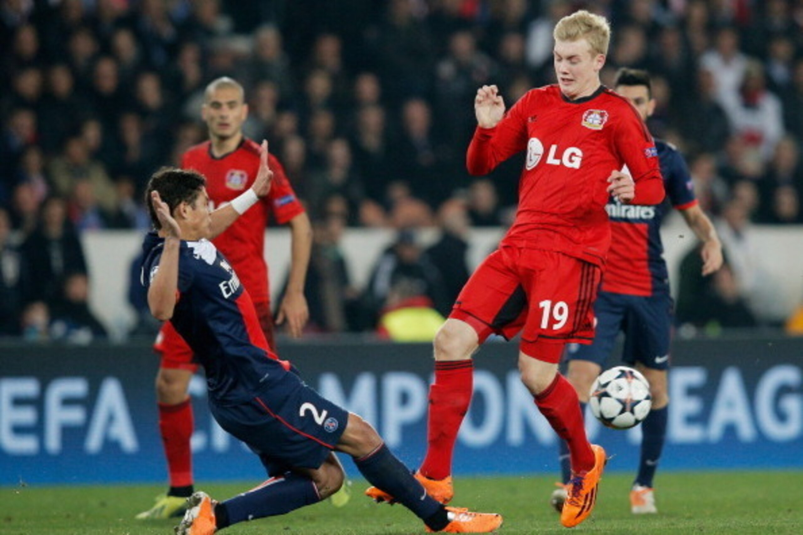 PARIS, FRANCE - MARCH 12:  Thiago Silva of Paris Saint-Germain tackles Julian Brandt of Bayer Leverkusen during the UEFA Champions League Round of 16 second leg match between Paris Saint-Germain FC and Bayer Leverkusen at Parc des Princes on March 12, 201