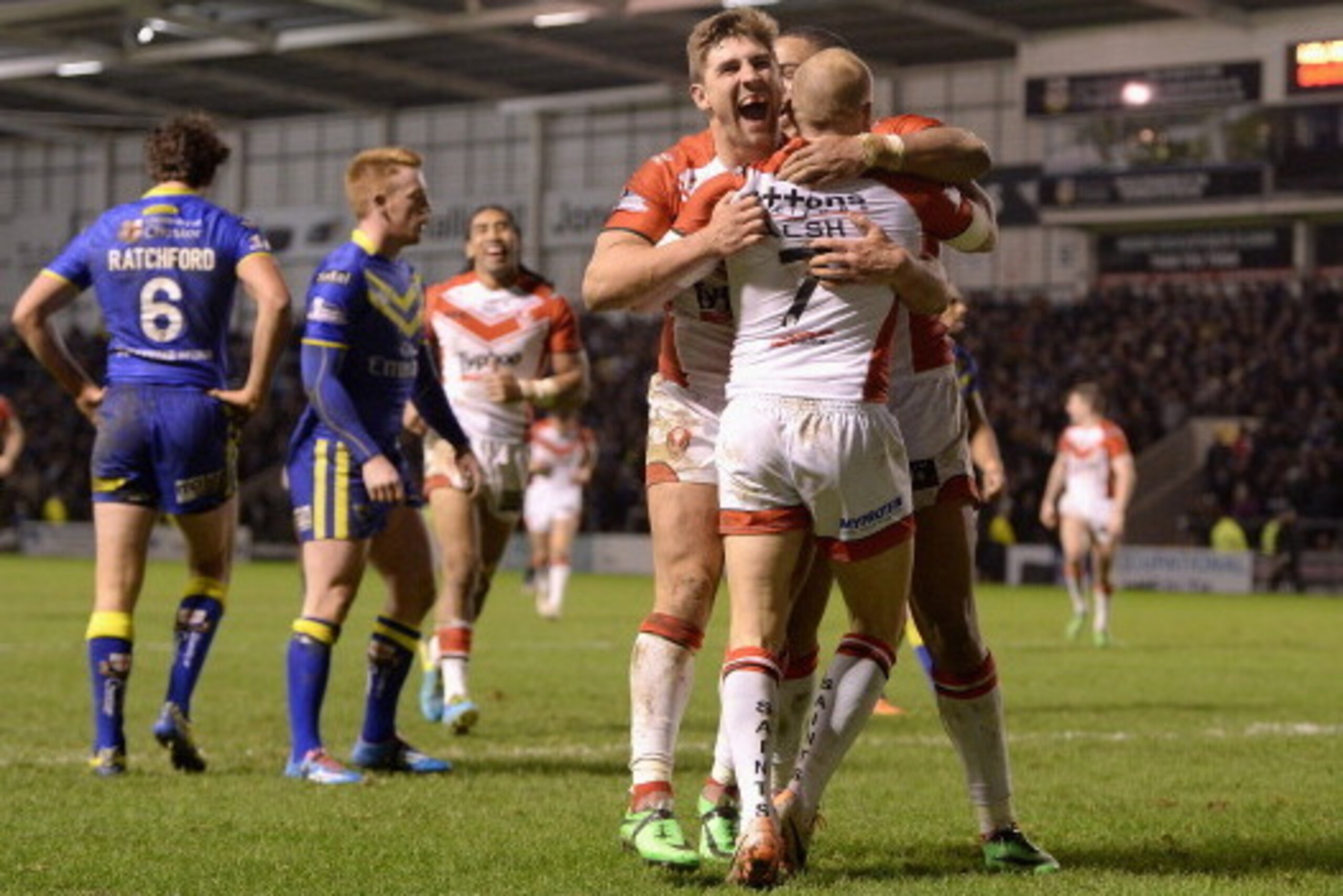 WARRINGTON, ENGLAND - FEBRUARY 13:  Luke Walsh of St Helens is congratulated on his try by teammate Tommy Makinson during the Super League match between Warrington Wolves and St Helens at The Halliwell Jones Stadium on February 13, 2014 in Warrington, Eng