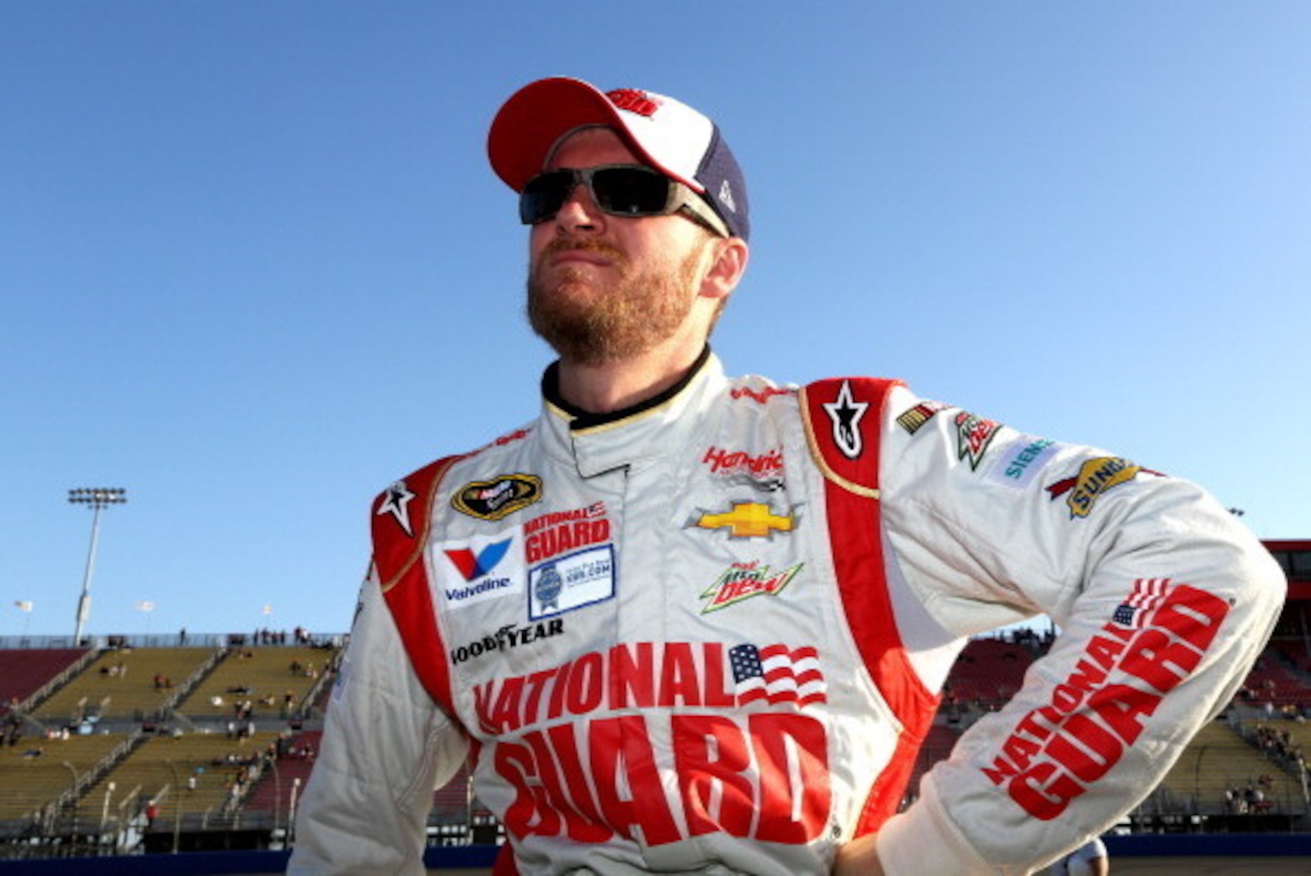 FONTANA, CA - MARCH 21:  Dale Earnhardt Jr., driver of the #88 National Guard Chevrolet, stands on the grid during qualifying for the NASCAR Sprint Cup Series Auto Club 400 at Auto Club Speedway on March 21, 2014 in Fontana, California.  (Photo by Jerry M