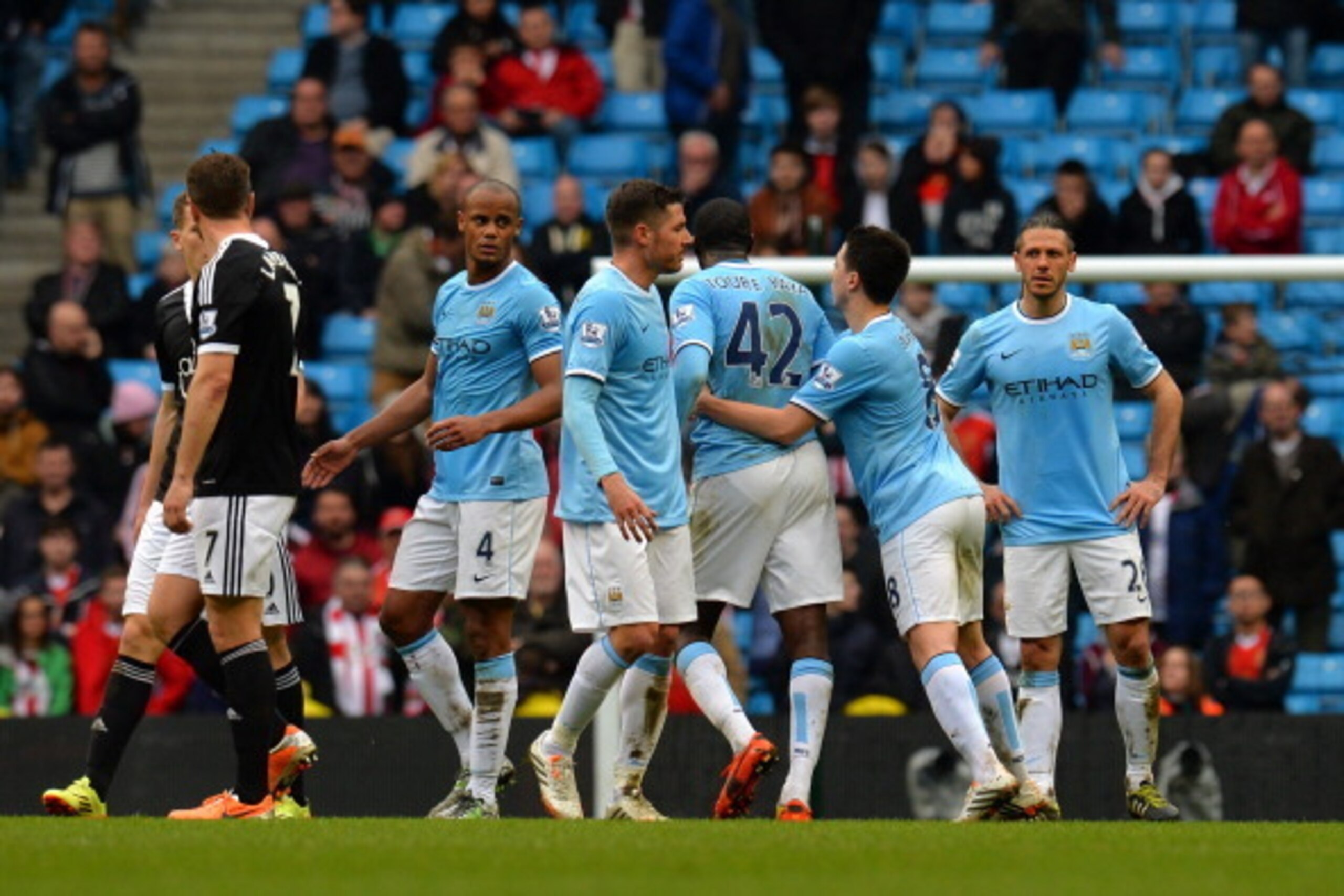 MANCHESTER, ENGLAND - APRIL 05:  Samir Nasri of Manchester City tries to separate arguing teamates Martin Demichelis  (R) and Yaya Toure (L) during the Barclays Premier League match between Manchester City and Southampton at Etihad Stadium on April 5, 201