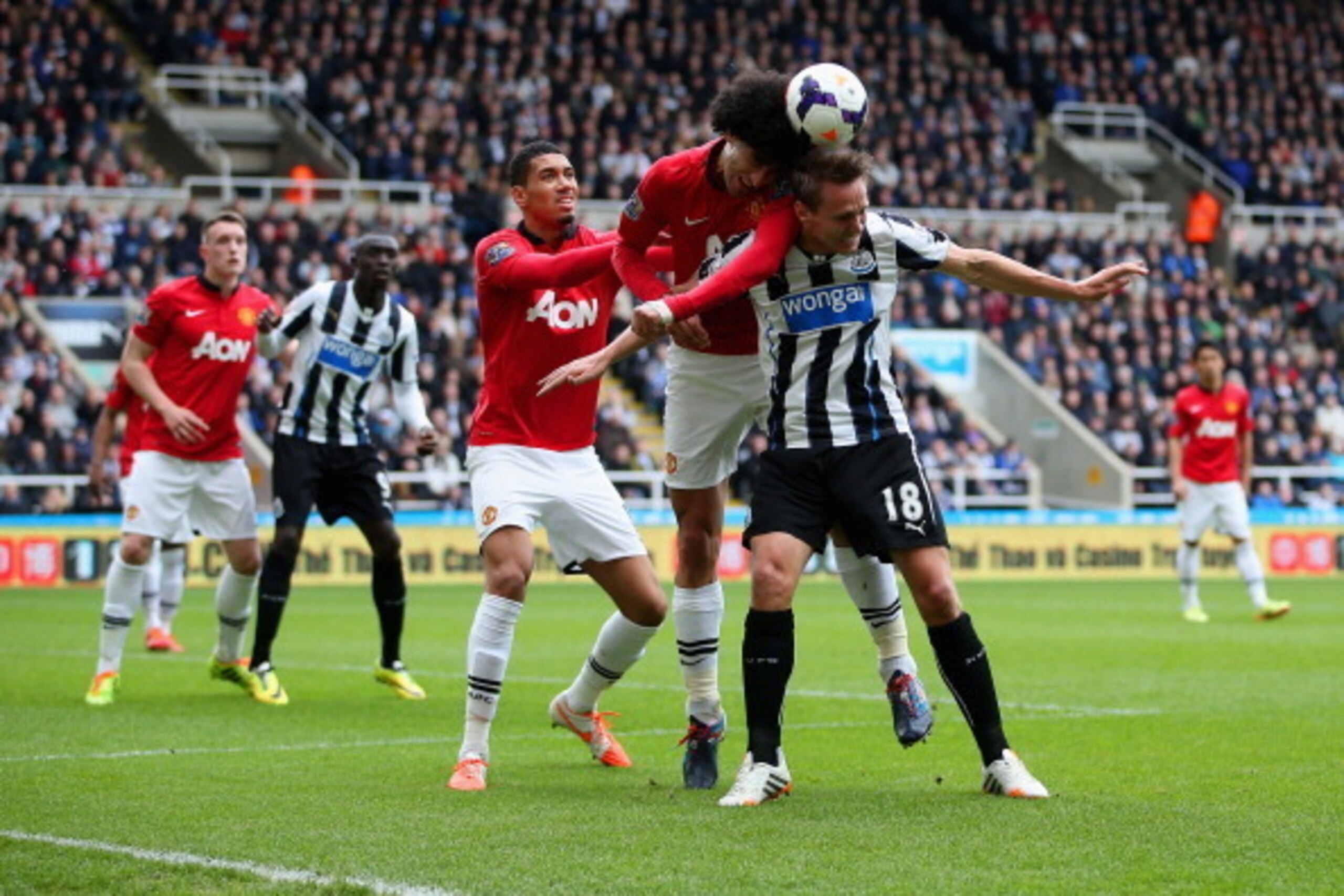NEWCASTLE UPON TYNE, ENGLAND - APRIL 05: Chris Smalling and Marouane Fellaini of Manchester United put Luuk de Jong of Newcastle United under pressure during the Barclays Premier League match between Newcastle United and Manchester United  at St James' Pa