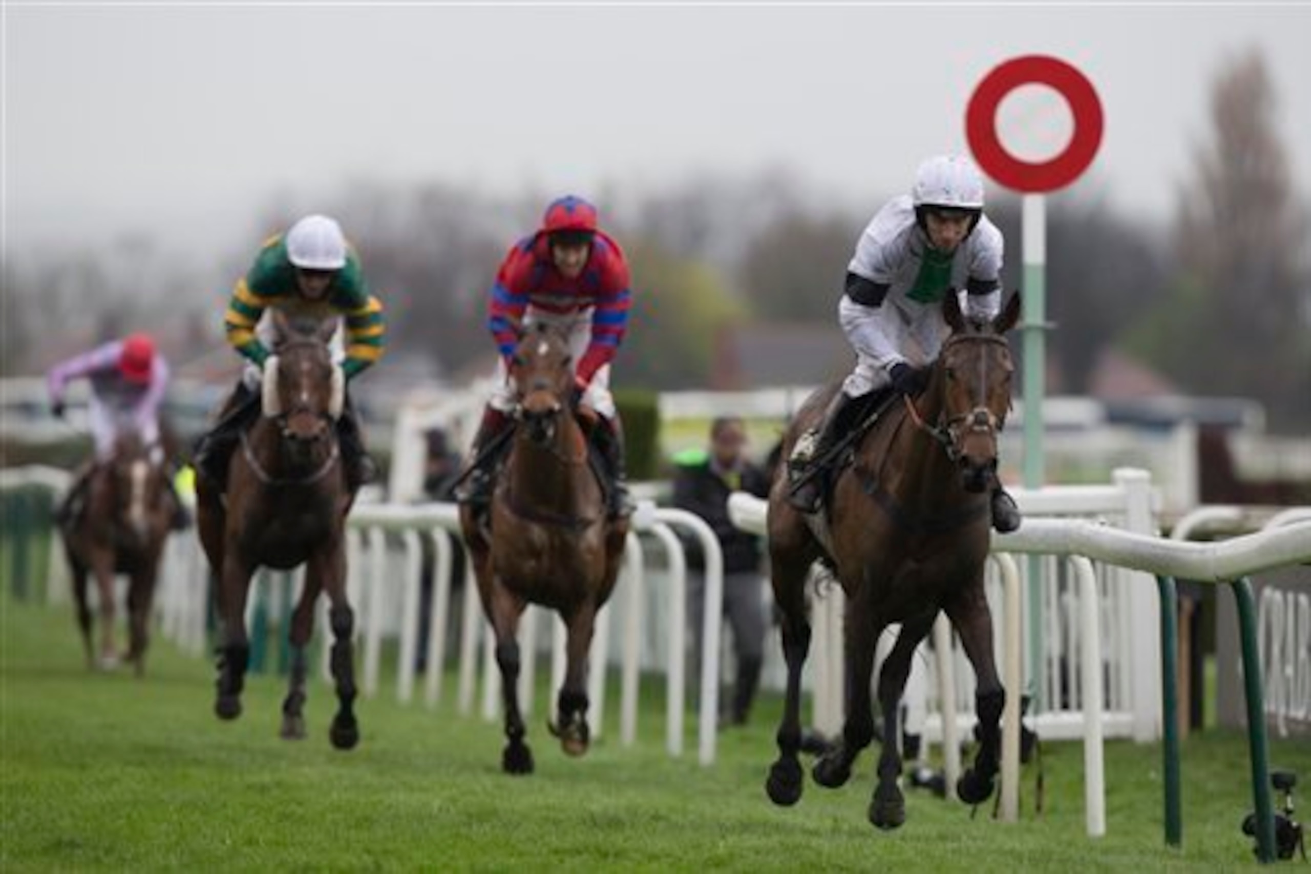 The horses cross the Aintree finish line.