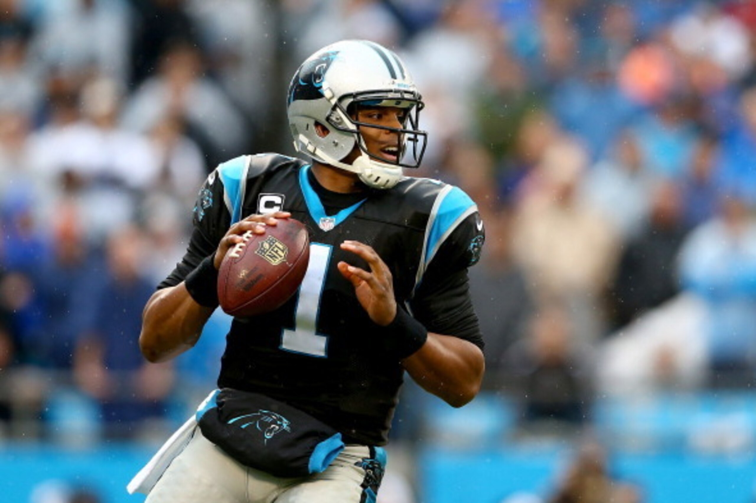 CHARLOTTE, NC - DECEMBER 22:  Cam Newton #1 of the Carolina Panthers drops back to pass during their game against the New Orleans Saints at Bank of America Stadium on December 22, 2013 in Charlotte, North Carolina.  (Photo by Streeter Lecka/Getty Images)