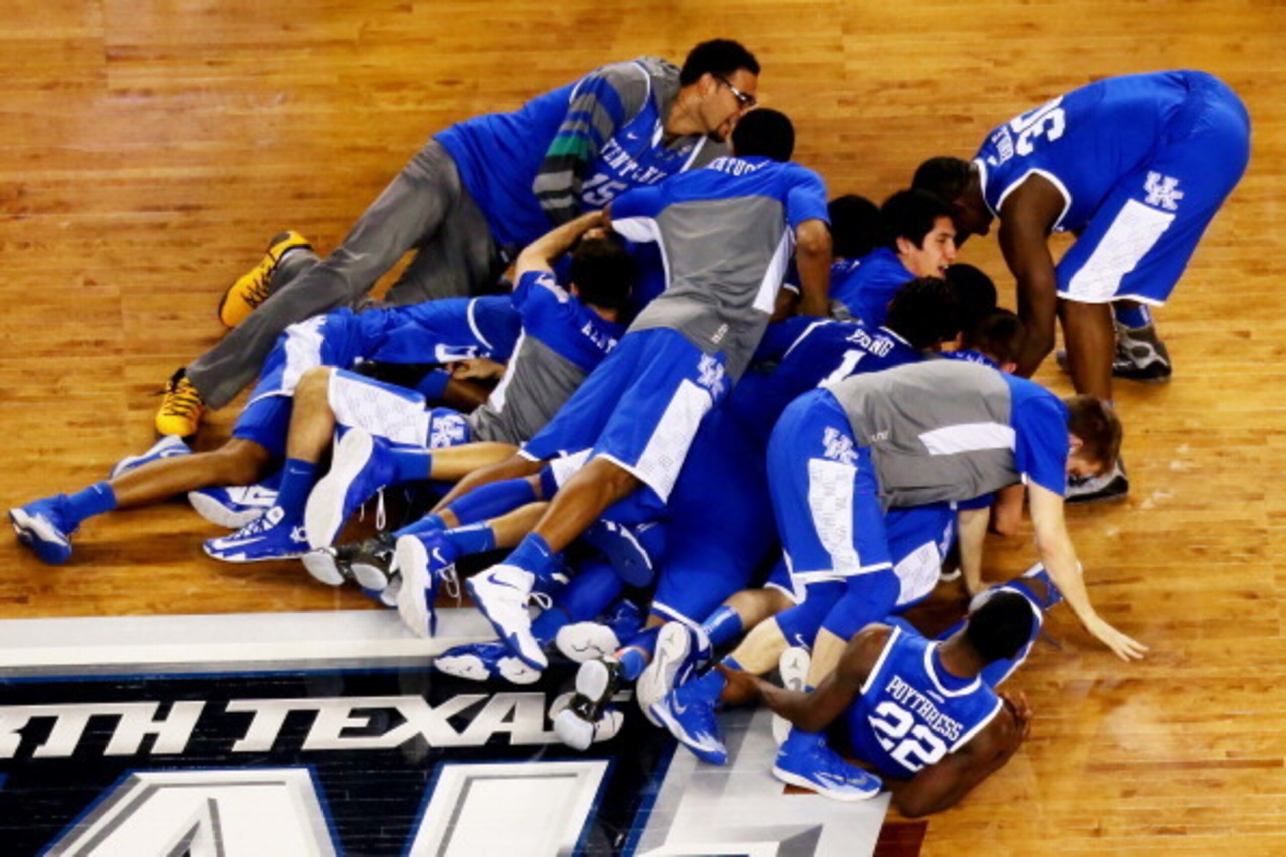ARLINGTON, TX - APRIL 05:  The Kentucky Wildcats celebrate after defeating the Wisconsin Badgers 74-73 in the NCAA Men's Final Four Semifinal at AT&T Stadium on April 5, 2014 in Arlington, Texas.  (Photo by Ronald Martinez/Getty Images)