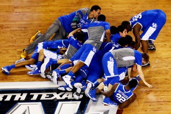 ARLINGTON, TX - APRIL 05:  The Kentucky Wildcats celebrate after defeating the Wisconsin Badgers 74-73 in the NCAA Men's Final Four Semifinal at AT&T Stadium on April 5, 2014 in Arlington, Texas.  (Photo by Ronald Martinez/Getty Images)