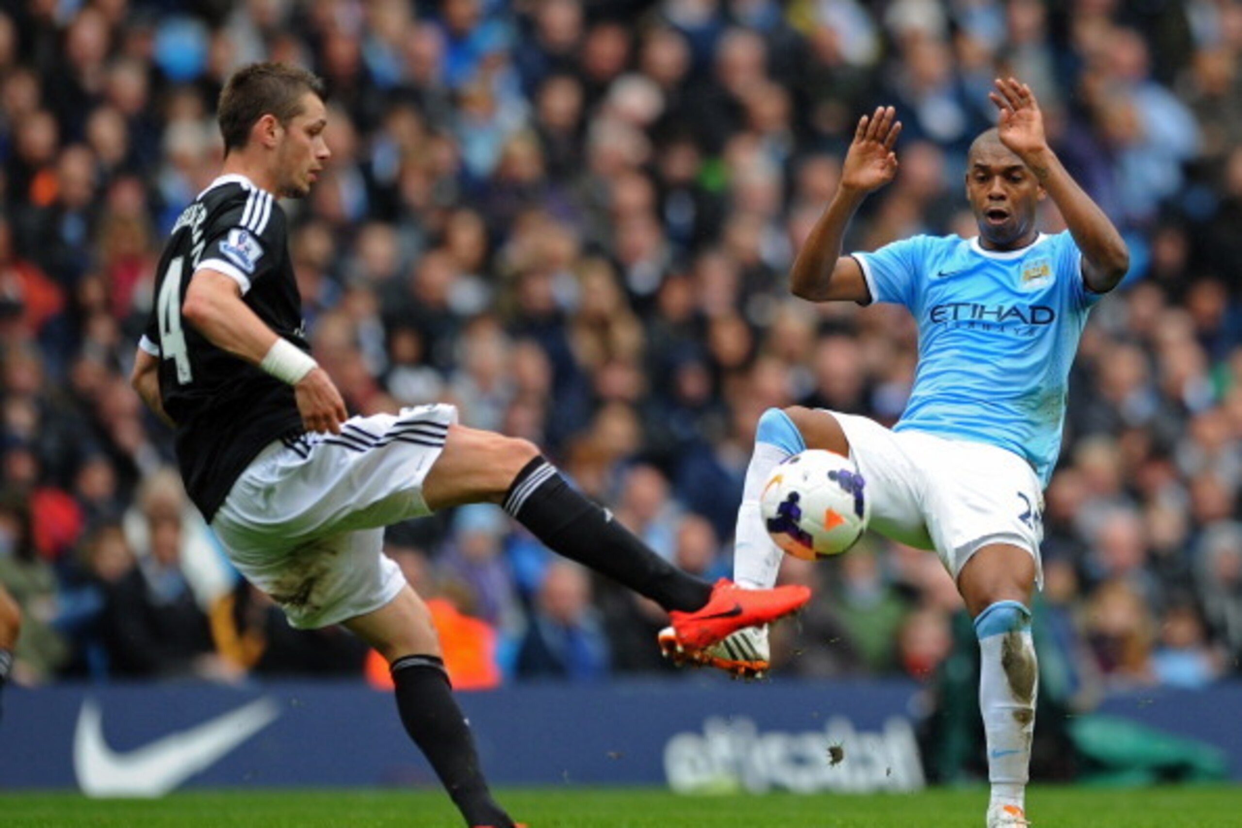 MANCHESTER, ENGLAND - APRIL 05:  Morgan Schneiderlin of Southampton and Fernandinho of Manchester City compete for the ball during the Barclays Premier League match between Manchester City and Southampton at Etihad Stadium on April 5, 2014 in Manchester, 