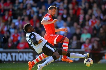 SOUTHAMPTON, ENGLAND - MARCH 15:  Daniel Sanchez Ayala of Norwich City tackles Morgan Schneiderlin of Southampton during the Barclays Premier League match between Southampton and Norwich City at St Mary's Stadium on March 15, 2014 in Southampton, England.