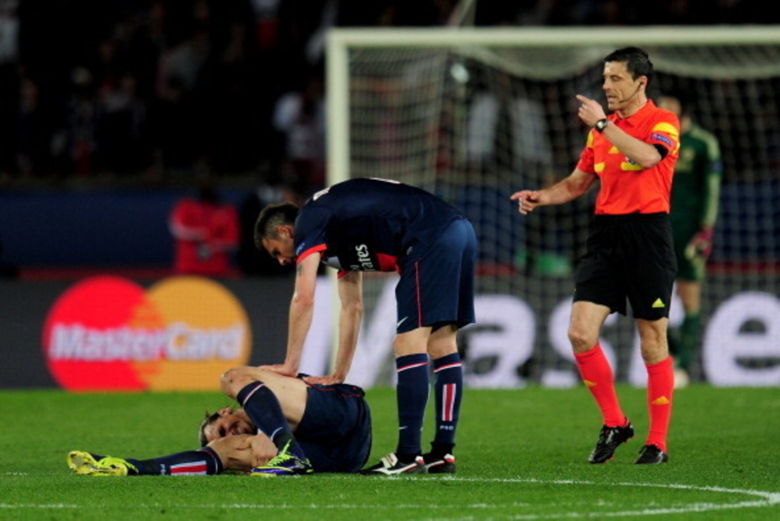 PARIS, FRANCE - APRIL 02:  Thiago Motta of PSG checks on teammate Zlatan Ibrahimovic after he goes down injured during the UEFA Champions League quarter final, first leg match between Paris Saint Germain and Chelsea at Parc des Princes on April 2, 2014 in