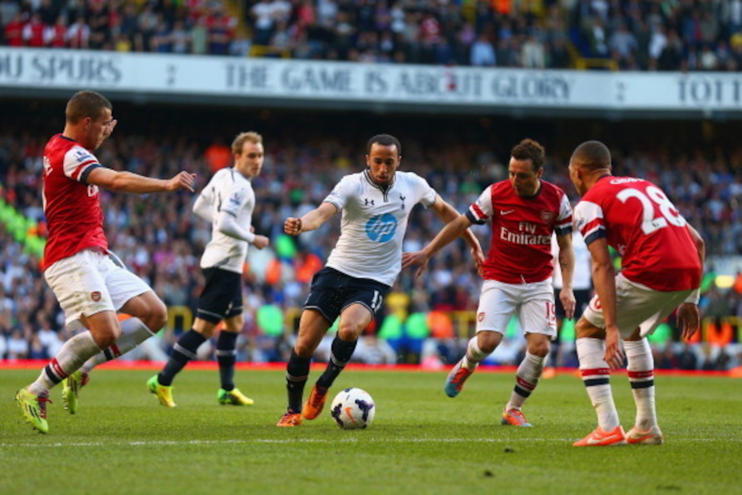 LONDON, ENGLAND - MARCH 16:  Andros Townsend of Tottenham Hotspur is closed down by Lukas Podolski, Santi Cazorla and Kieran Gibbs of Arsenal during the Barclays Premier League match between Tottenham Hotspur and Arsenal at White Hart Lane on March 16, 20