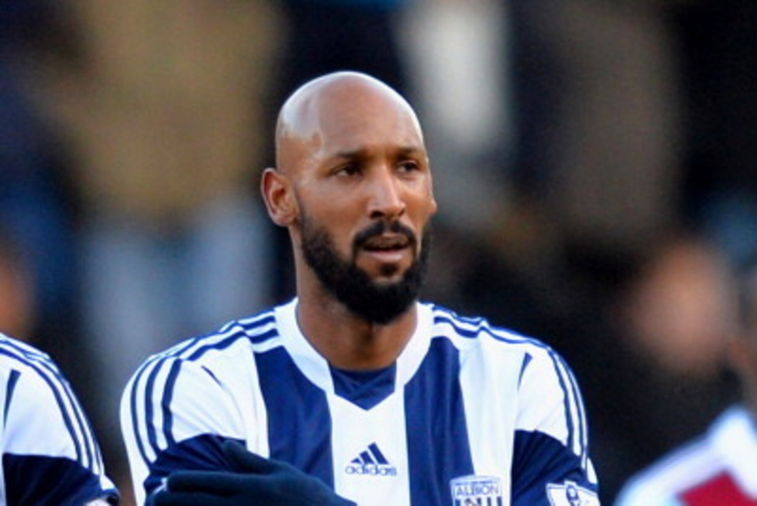 LONDON, ENGLAND - DECEMBER 28:  Nicolas Anelka of West Brom touches his sleeve as he celebrates scoring their first goal during the Barclays Premier League match between West Ham United and West Bromwich Albion at Boleyn Ground on December 28, 2013 in Lon