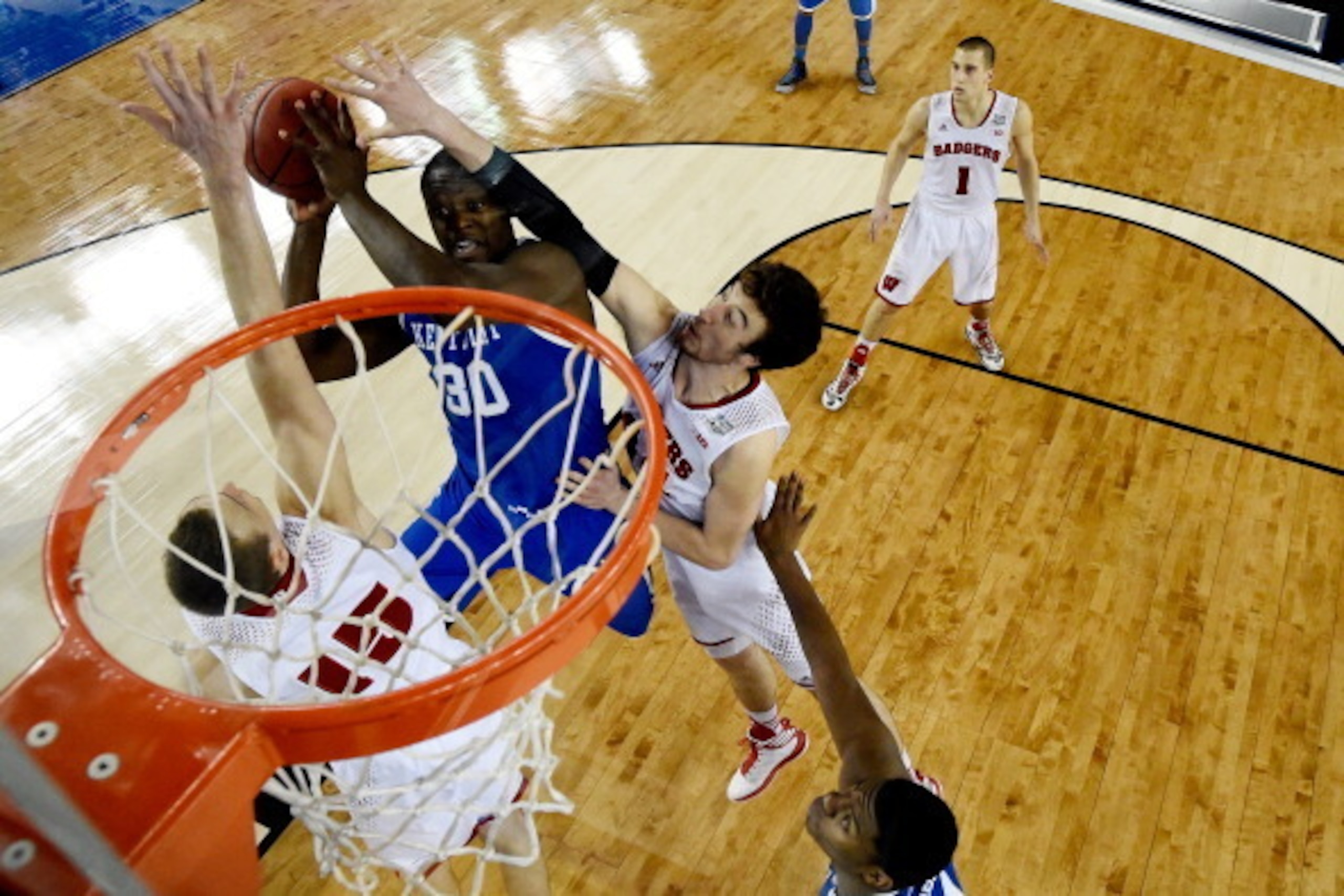 ARLINGTON, TX - APRIL 05: Julius Randle #30 of the Kentucky Wildcats goes to the basket as Frank Kaminsky #44 of the Wisconsin Badgers defends during the NCAA Men's Final Four Semifinal at AT&T Stadium on April 5, 2014 in Arlington, Texas. (Photo by Chris