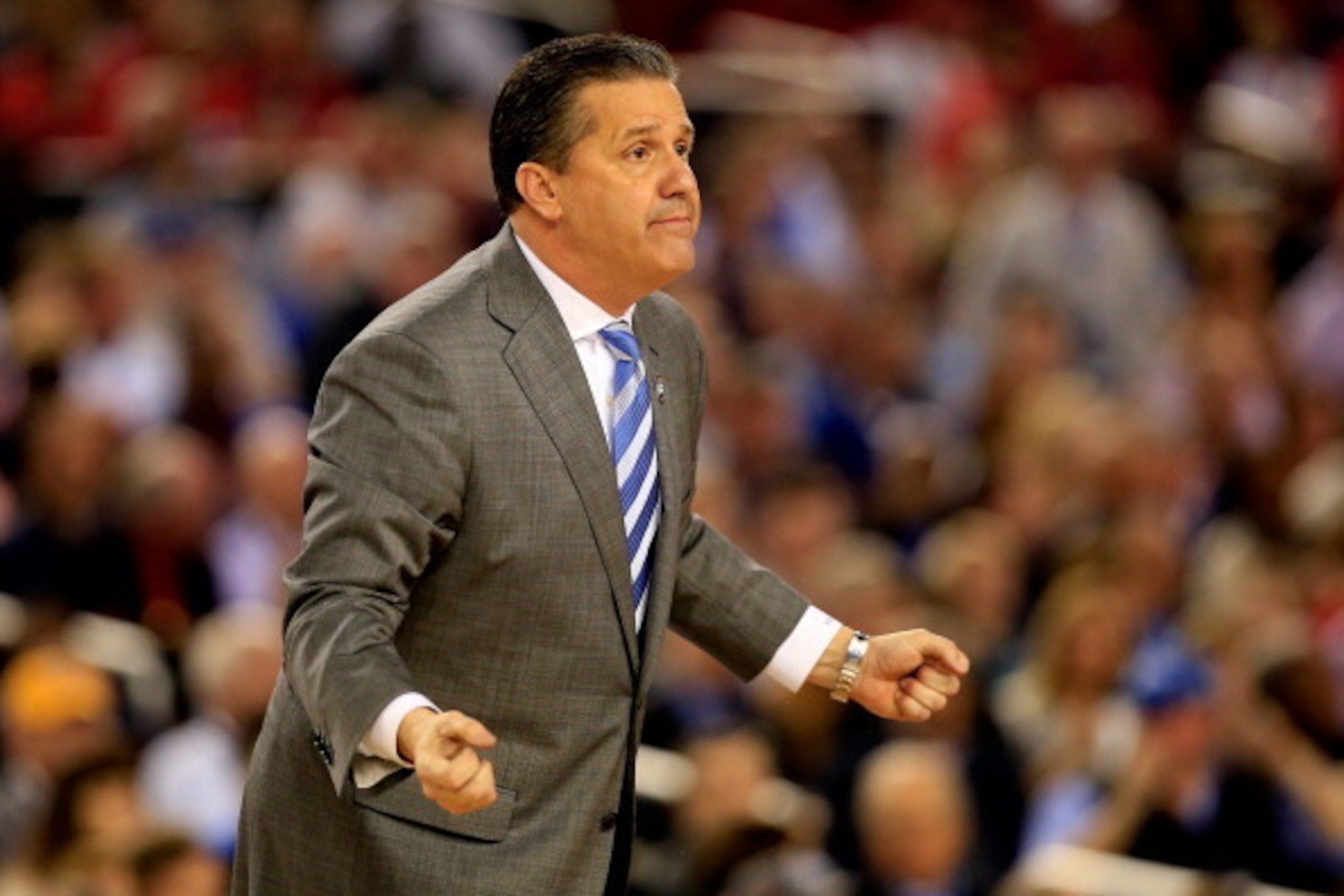 ARLINGTON, TX - APRIL 05:  Head coach John Calipari of the Kentucky Wildcats motions to his players during the NCAA Men's Final Four Semifinal against the Wisconsin Badgers at AT&T Stadium on April 5, 2014 in Arlington, Texas.  (Photo by Jamie Squire/Gett