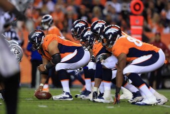 DENVER, CO - SEPTEMBER 23: Center Manny Ramirez #66 of the Denver Broncos prepares to snap the ball as the Broncos offensive line faces the Oakland Raiders defensive line at Sports Authority Field at Mile High on September 23, 2013 in Denver, Colorado. DENVER, CO - SEPTEMBER 23: Center Manny Ramirez #66 of the Denver Broncos prepares to snap the ball as the Broncos offensive line faces the Oakland Raiders defensive line at Sports Authority Field at Mile High on September 23, 2013 in Denver, Colorado.