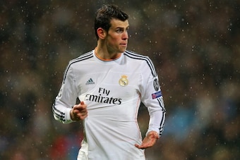 MADRID, SPAIN - APRIL 02: Gareth Bale of Real Madrid reacts to a challenge during the UEFA Champions League Quarter Final first leg match between Real Madrid and Borussia Dortmund at Estadio Santiago Bernabeu on April 2, 2014 in Madrid, Spain.  (Photo by 
