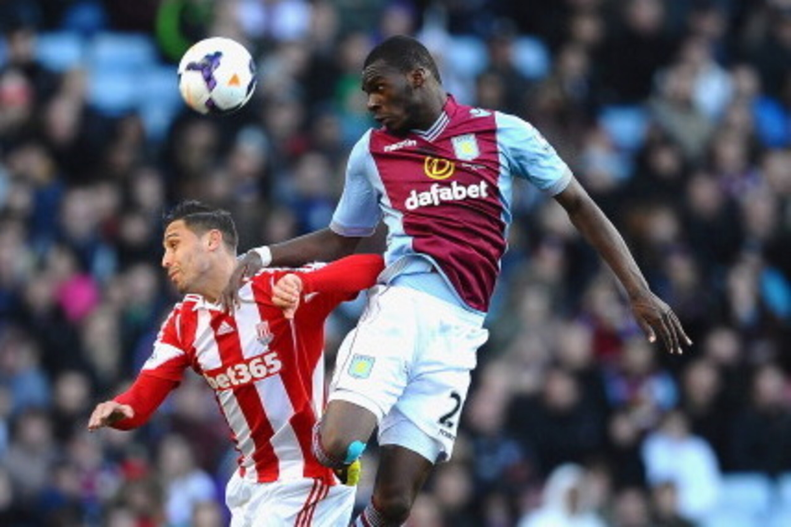 BIRMINGHAM, ENGLAND - MARCH 23:  Christian Benteke of Aston Villa rises above Geoff Cameron of Stoke to win a header during the Barclays Premier League match between Aston Villa and Stoke City at Villa Park on March 23, 2014 in Birmingham, England.  (Phot