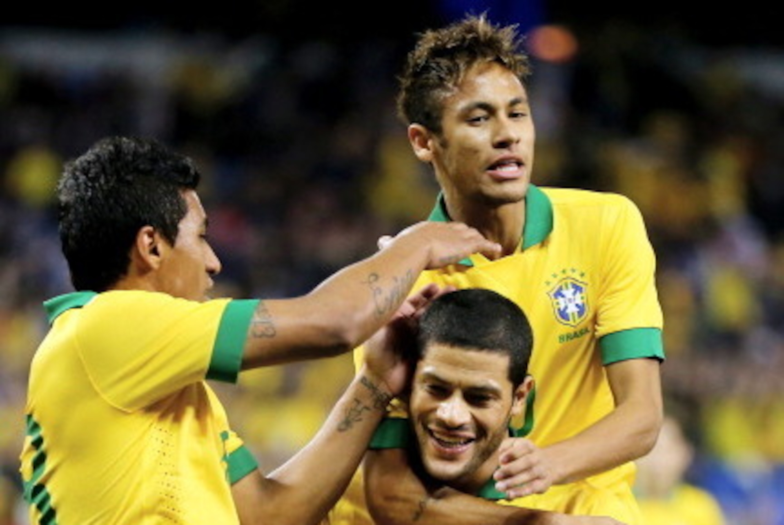 TORONTO, ON - NOVEMBER 19:  Hulk #19 of Brazil  is congratulated by teammates Paulinho #18 and Neymar #10 after scoring in the first half against Chile during a friendly match at Rogers Centre on November 19, 2013 in Toronto, Canada.  (Photo by Elsa/Getty