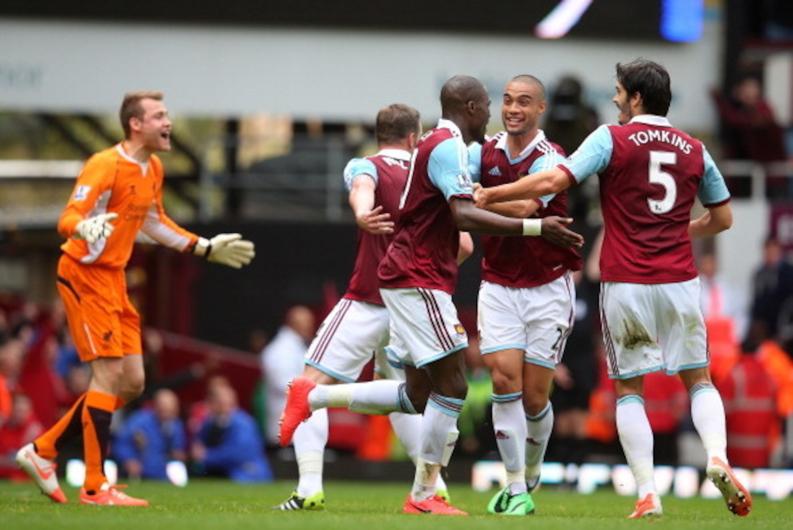 LONDON, ENGLAND - APRIL 06:  Guy Demel (C) of West Ham celebrates with teammates Winston Reid (2nd R) and James Tomkins (R) after scoring a goal to level the scores at 1-1 during the Barclays Premier League match between West Ham United and Liverpool at B
