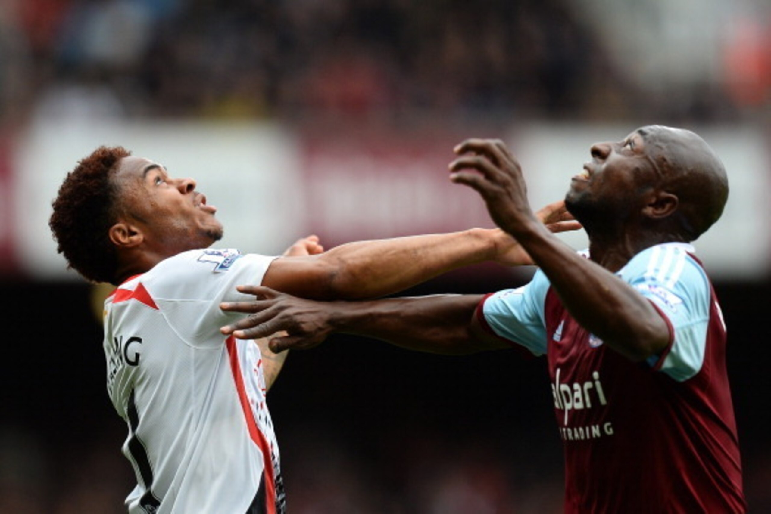 LONDON, ENGLAND - APRIL 06:  Raheem Sterling of Liverpool competes for the ball with Pablo Armero of West Ham during the Barclays Premier League match between West Ham United and Liverpool at Boleyn Ground on April 6, 2014 in London, England.  (Photo by M