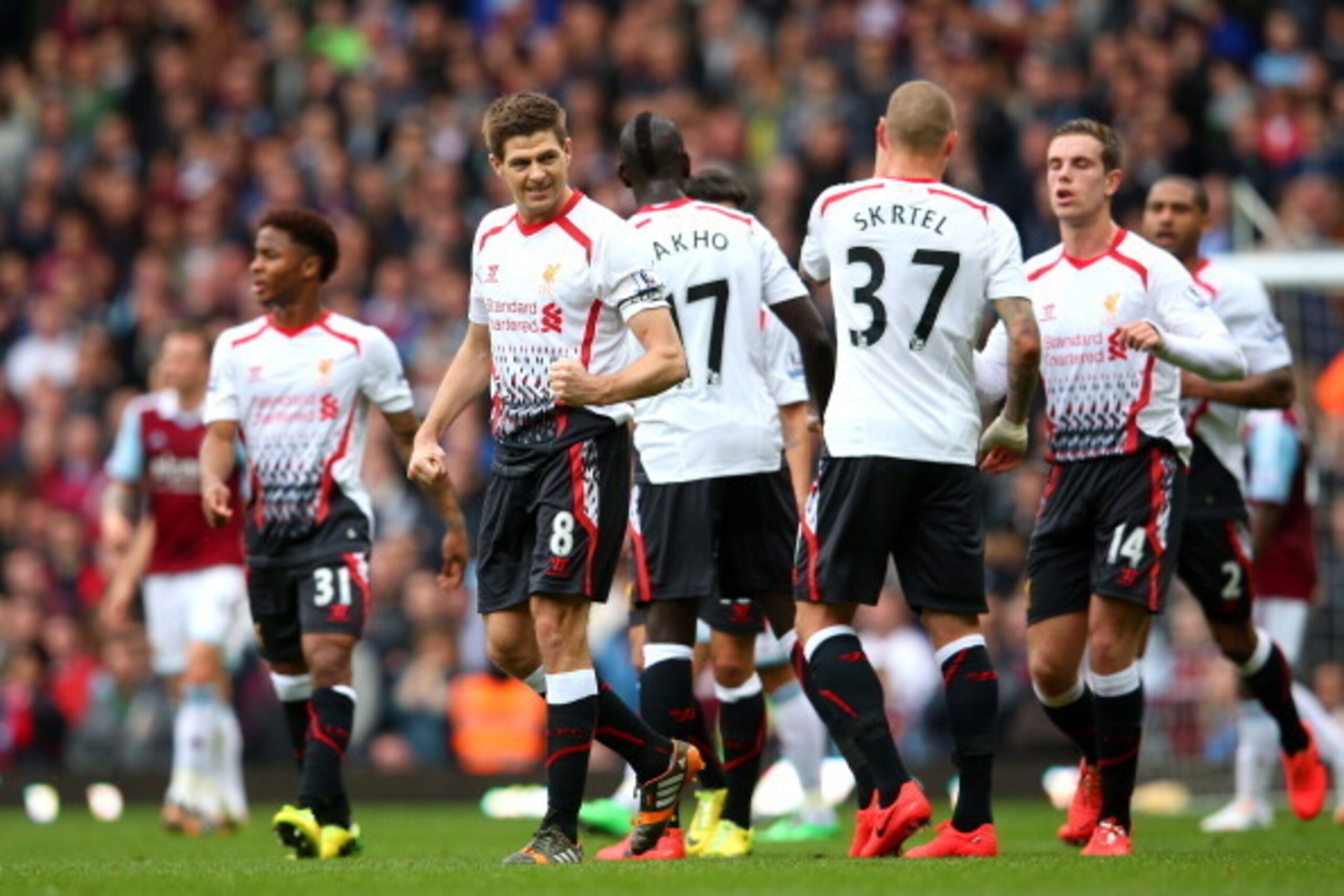 LONDON, ENGLAND - APRIL 06:  Steven Gerrard #8 of Liverpool celebrates after scoring the opening goal from the penalty spot during the Barclays Premier League match between West Ham United and Liverpool at Boleyn Ground on April 6, 2014 in London, England