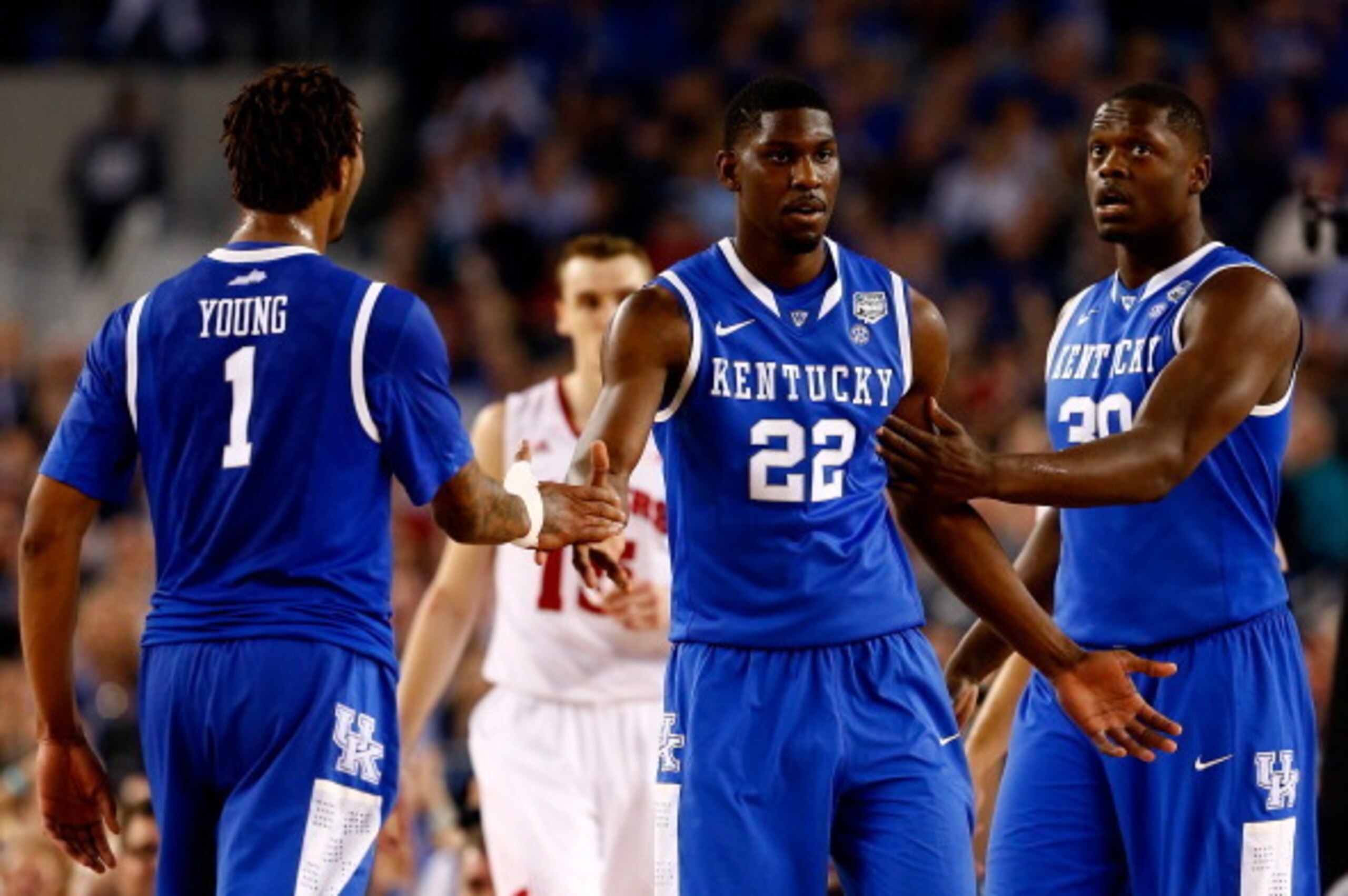 ARLINGTON, TX - APRIL 05: Alex Poythress #22 celebrates with James Young #1 and Julius Randle #30 of the Kentucky Wildcats during the NCAA Men's Final Four Semifinal against the Wisconsin Badgers at AT&T Stadium on April 5, 2014 in Arlington, Texas.  (Pho