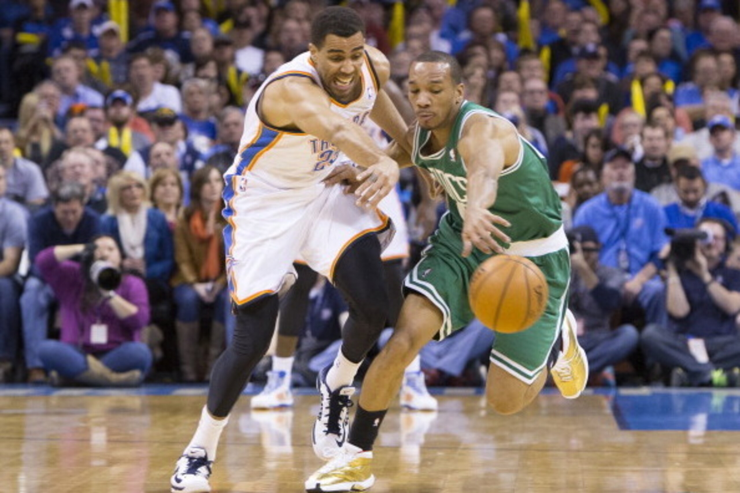 OKLAHOMA CITY, OK - JANUARY 5, 2014:  Avery Bradley #0 of the Boston Celtics chases the ball against Thabo Sefolosha #25 of the Oklahoma City Thunder at the Chesapeake Arena on January 5, 2014 in Oklahoma City, Oklahoma. NOTE TO USER:  User expressly ackn