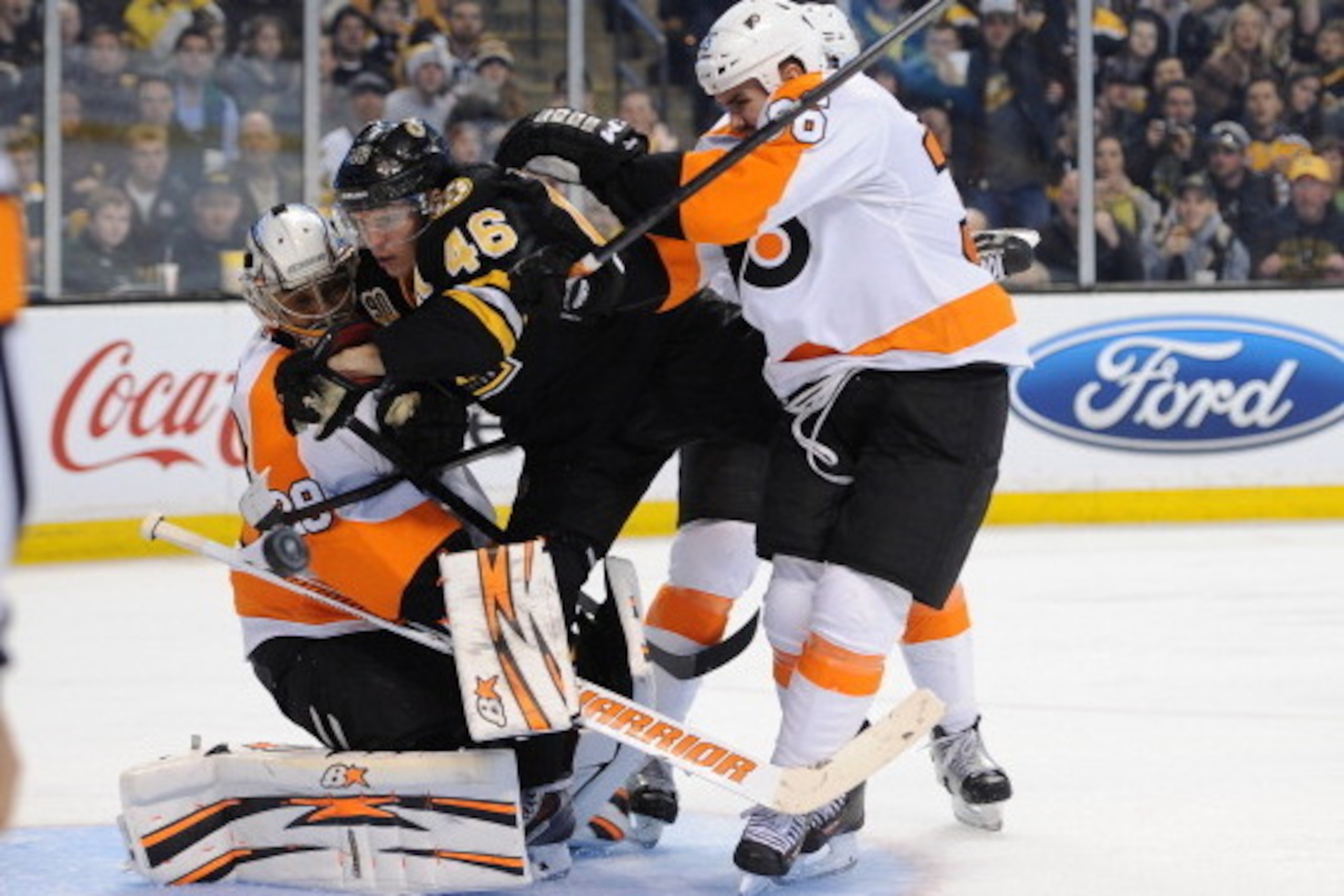 BOSTON, MA - APRIL 5: David Krejci #46 of the Boston Bruins gets shoved against Ray Emery #29 and Zac Rinaldo #36 of the Philadelphia Flyers at the TD Garden on April 5, 2014 in Boston, Massachusetts.  (Photo by Brian Babineau/NHLI via Getty Images)