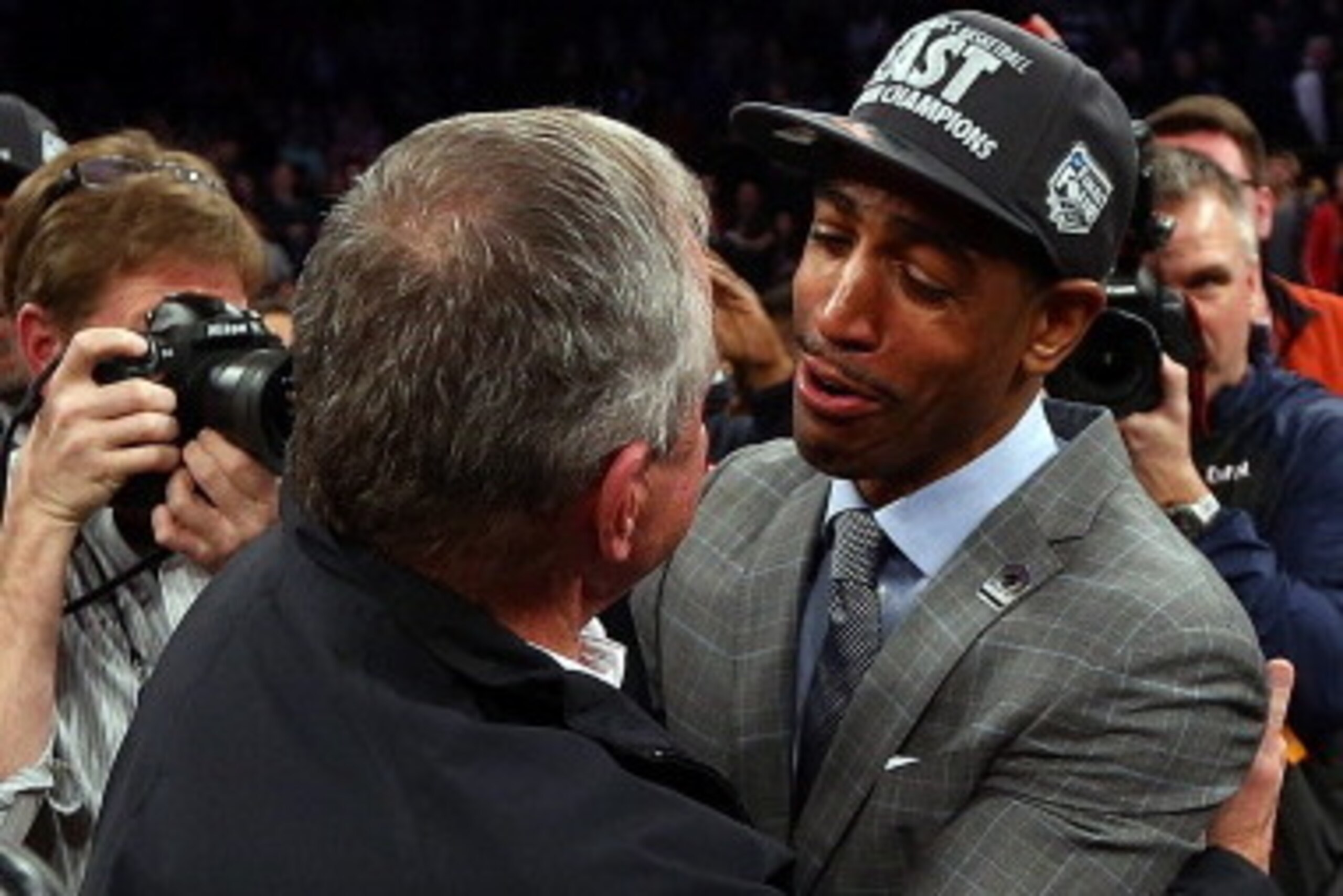 NEW YORK, NY - MARCH 30:  Former Connecticut Huskies head coach Jim Calhoun hugs head coach Kevin Ollie of the Connecticut Huskies after they defeated the Michigan State Spartans to win the East Regional Final of the 2014 NCAA Men's Basketball Tournament 
