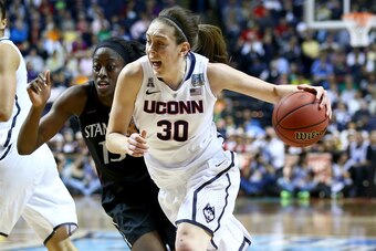 NASHVILLE, TN - APRIL 06: Breanna Stewart #30 of the Connecticut Huskies drives with the ball against Chiney Ogwumike #13 of the Stanford Cardinal in the second half during the NCAA Women's Final Four semifinal at Bridgestone Arena on April 6, 2014 in Nas