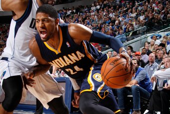 DALLAS, TX - MARCH 9: Paul George #24 of the Indiana Pacers drives against Vince Carter #25 of the Dallas Mavericks on March 9, 2014 at the American Airlines Center in Dallas, Texas. NOTE TO USER: User expressly acknowledges and agrees that, by downloadin