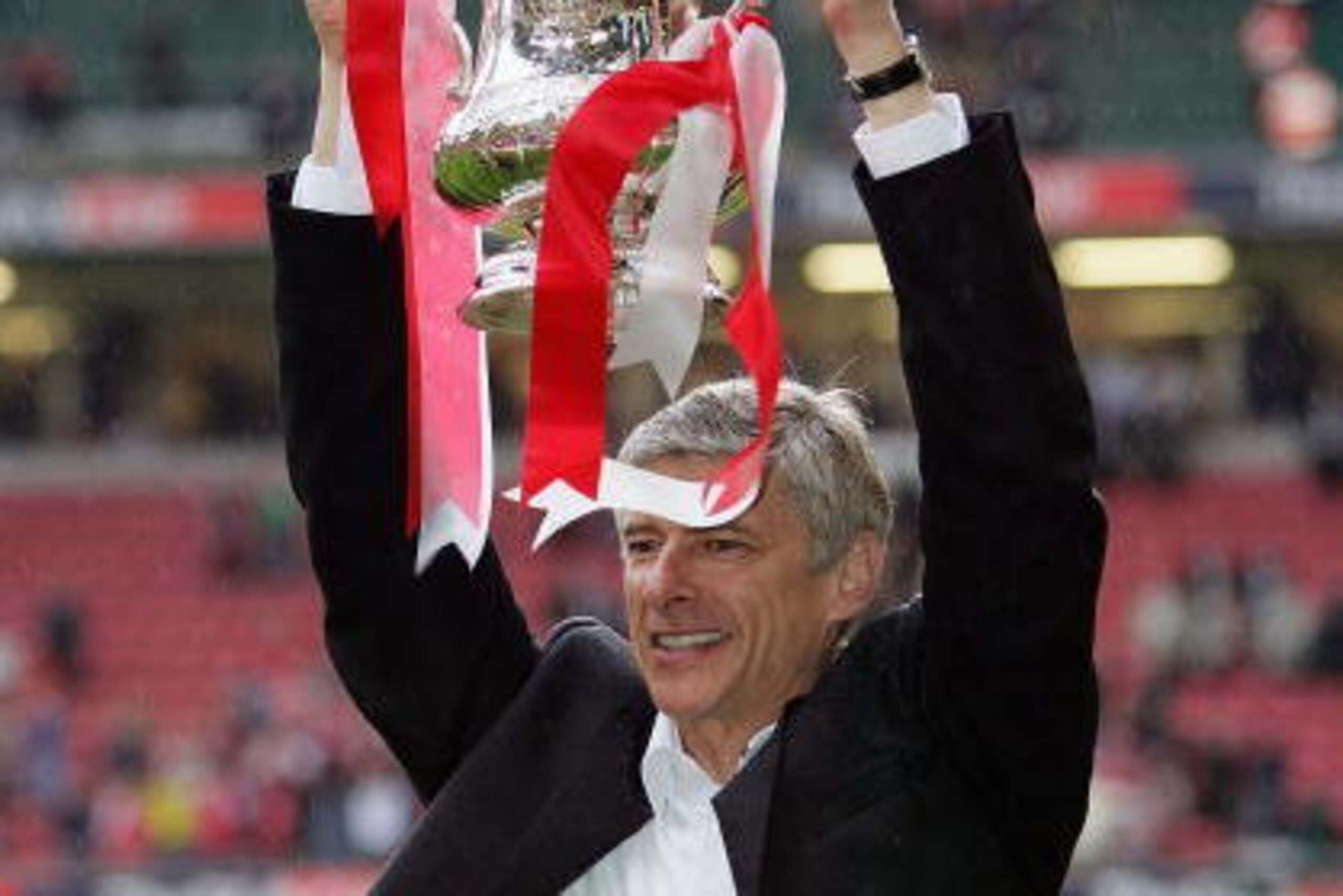 CARDIFF, UNITED KINGDOM - MAY 21: Arsenal Manager, Arsene Wenger holds aloft the trophy after winning the FA Cup Final between Arsenal and Manchester United 5-4 on penalty's at The Millennium Stadium on May 21, 2005 in Cardiff, Wales. (Photo by Ross Kin CARDIFF, UNITED KINGDOM - MAY 21: Arsenal Manager, Arsene Wenger holds aloft the trophy after winning the FA Cup Final between Arsenal and Manchester United 5-4 on penalty's at The Millennium Stadium on May 21, 2005 in Cardiff, Wales. (Photo by Ross Kin