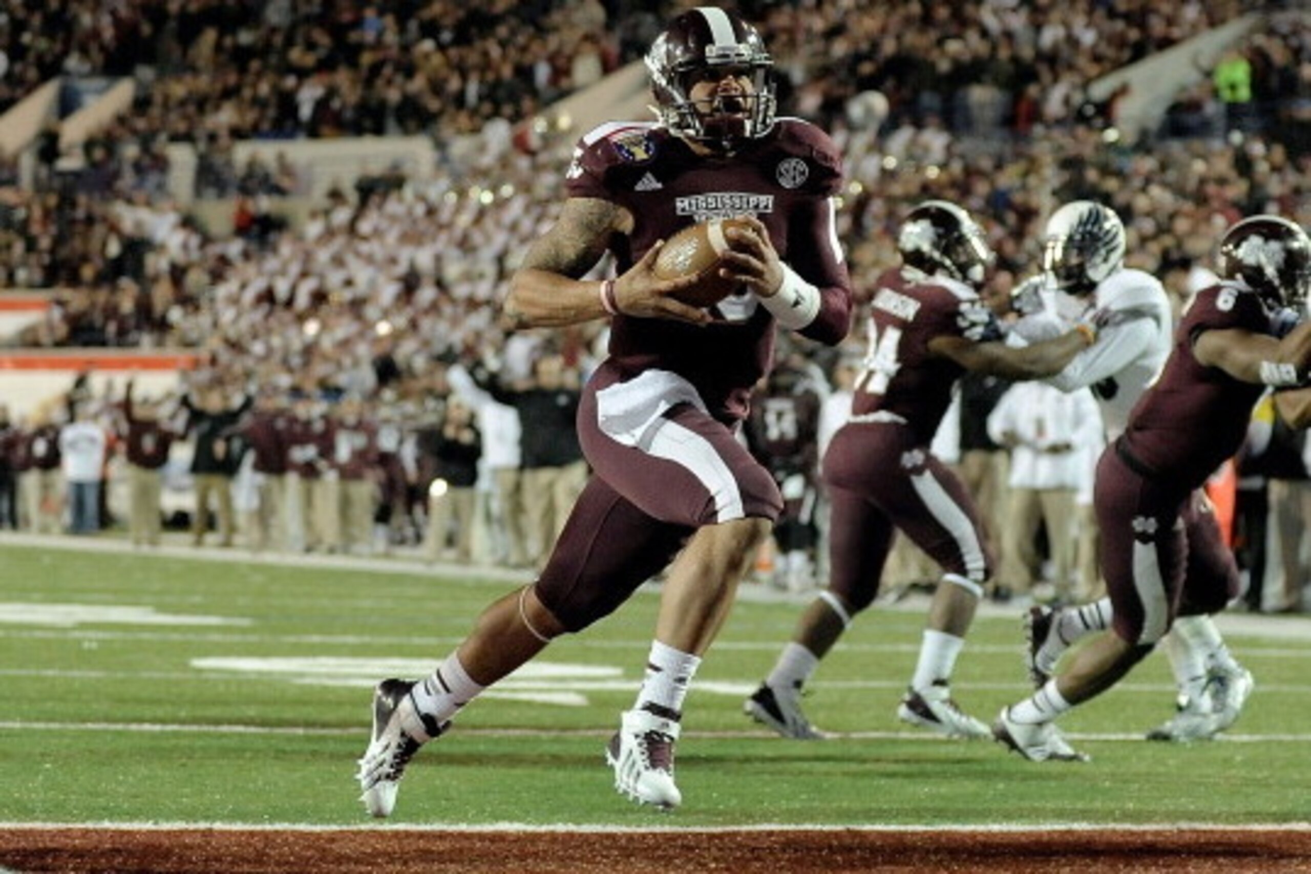 MEMPHIS, TN - DECEMBER 31:  Dak Prescott #15 of the Mississippi State Bulldogs rushes for a touchdown against the Rice Owls during the 55th annual AutoZone Liberty Bowl at Liberty Bowl Memorial Stadium on December 31, 2013 in Memphis, Tennessee.  Mississi