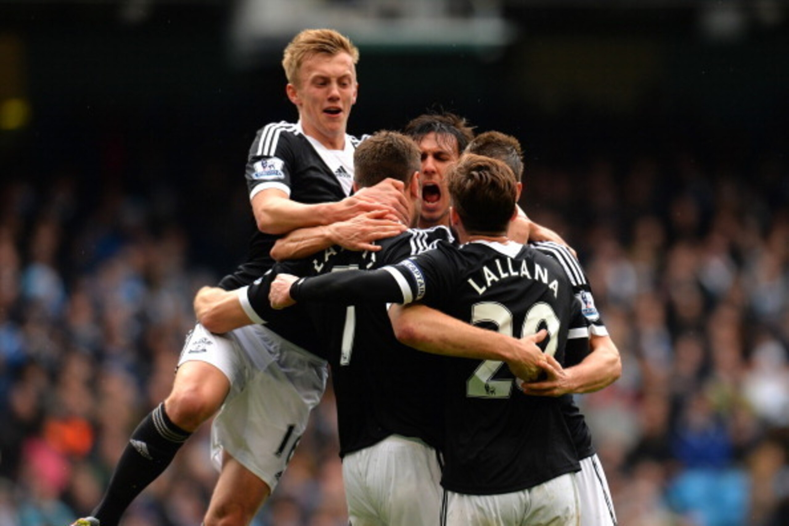 MANCHESTER, ENGLAND - APRIL 05:  Rickie Lambert (C) of Southampton is congratulated by teammates after scoring a goal from the penalty spot to level the scores at 1-1 during the Barclays Premier League match between Manchester City and Southampton at Etih