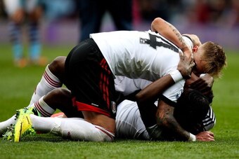 BIRMINGHAM, ENGLAND - APRIL 05:  Hugo Rodallega of Fulham is mobbed by team mates at the final whistle during the Barclays Premier League match between Aston Villa and Fulham at Villa Park on April 5, 2014 in Birmingham, England.  (Photo by Ben Hoskins/Ge