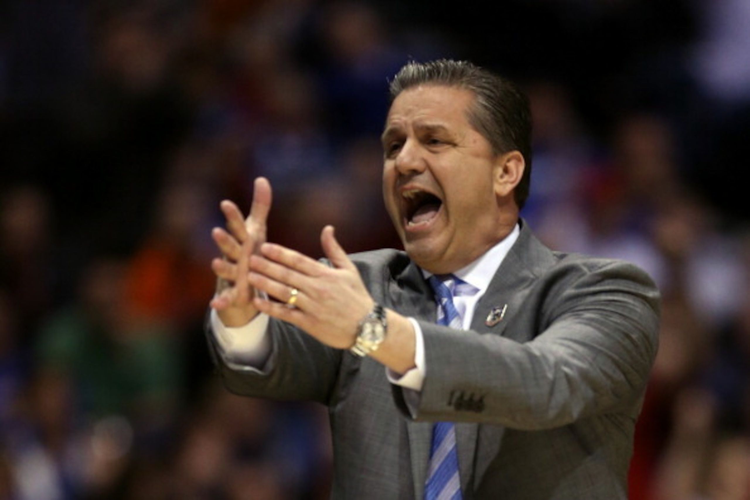 INDIANAPOLIS, IN - MARCH 28:  Head coach John Calipari of the Kentucky Wildcats shouts to his team against the Louisville Cardinals during the regional semifinal of the 2014 NCAA Men's Basketball Tournament at Lucas Oil Stadium on March 28, 2014 in Indian