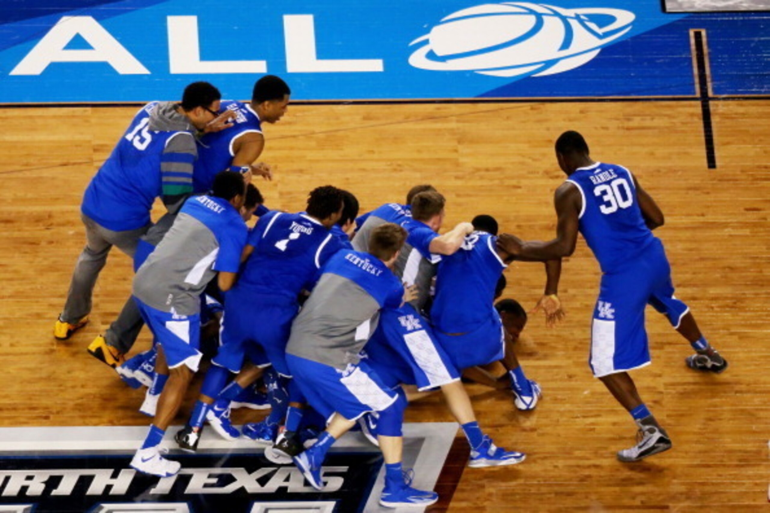 ARLINGTON, TX - APRIL 05:  The Kentucky Wildcats celebrate after defeating the Wisconsin Badgers 74-73 in the NCAA Men's Final Four Semifinal at AT&T Stadium on April 5, 2014 in Arlington, Texas.  (Photo by Ronald Martinez/Getty Images)
