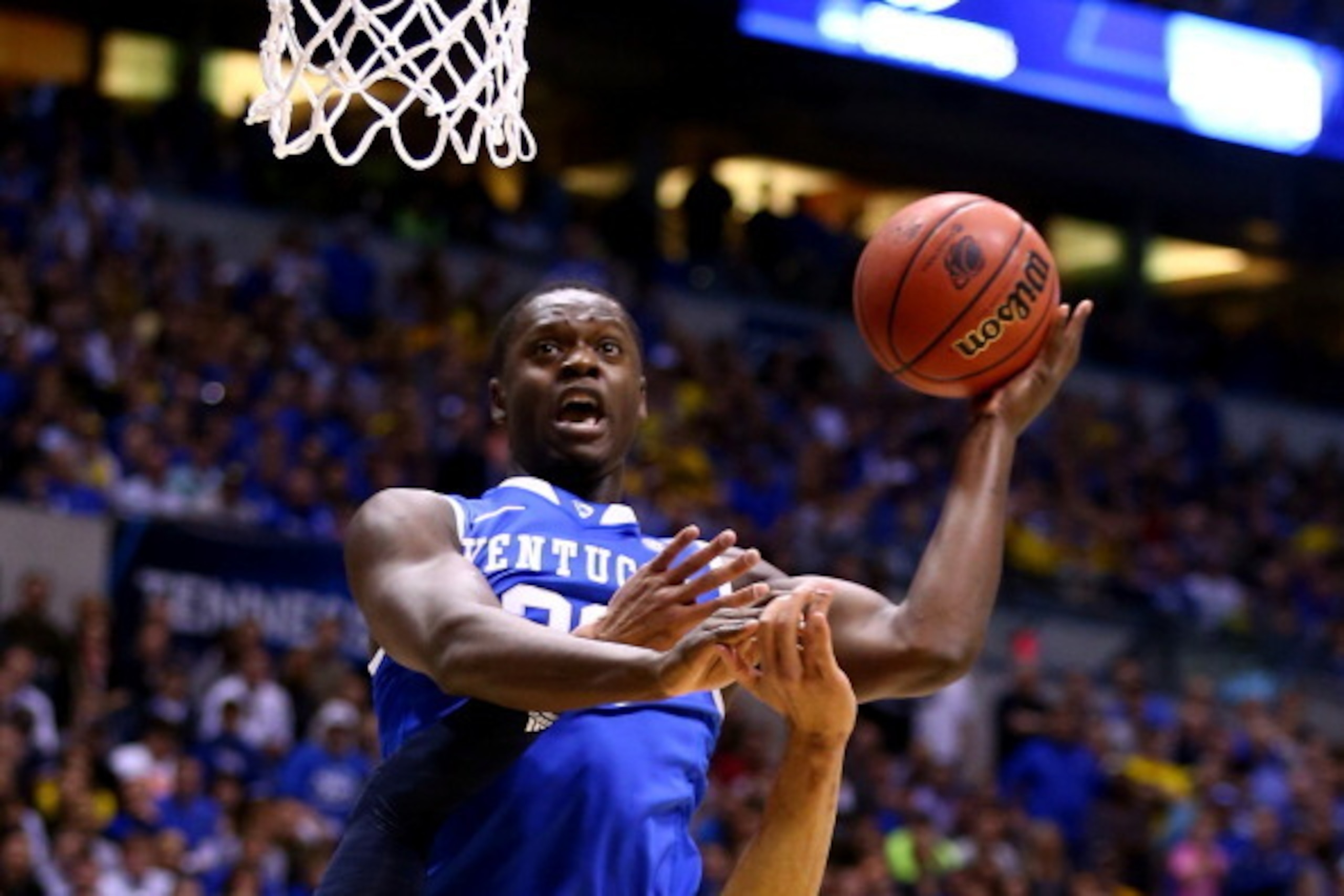 INDIANAPOLIS, IN - MARCH 30:  Julius Randle #30 of the Kentucky Wildcats shoots the ball over Jordan Morgan #52 of the Michigan Wolverines in the first half during the midwest regional final of the 2014 NCAA Men's Basketball Tournament at Lucas Oil Stadiu