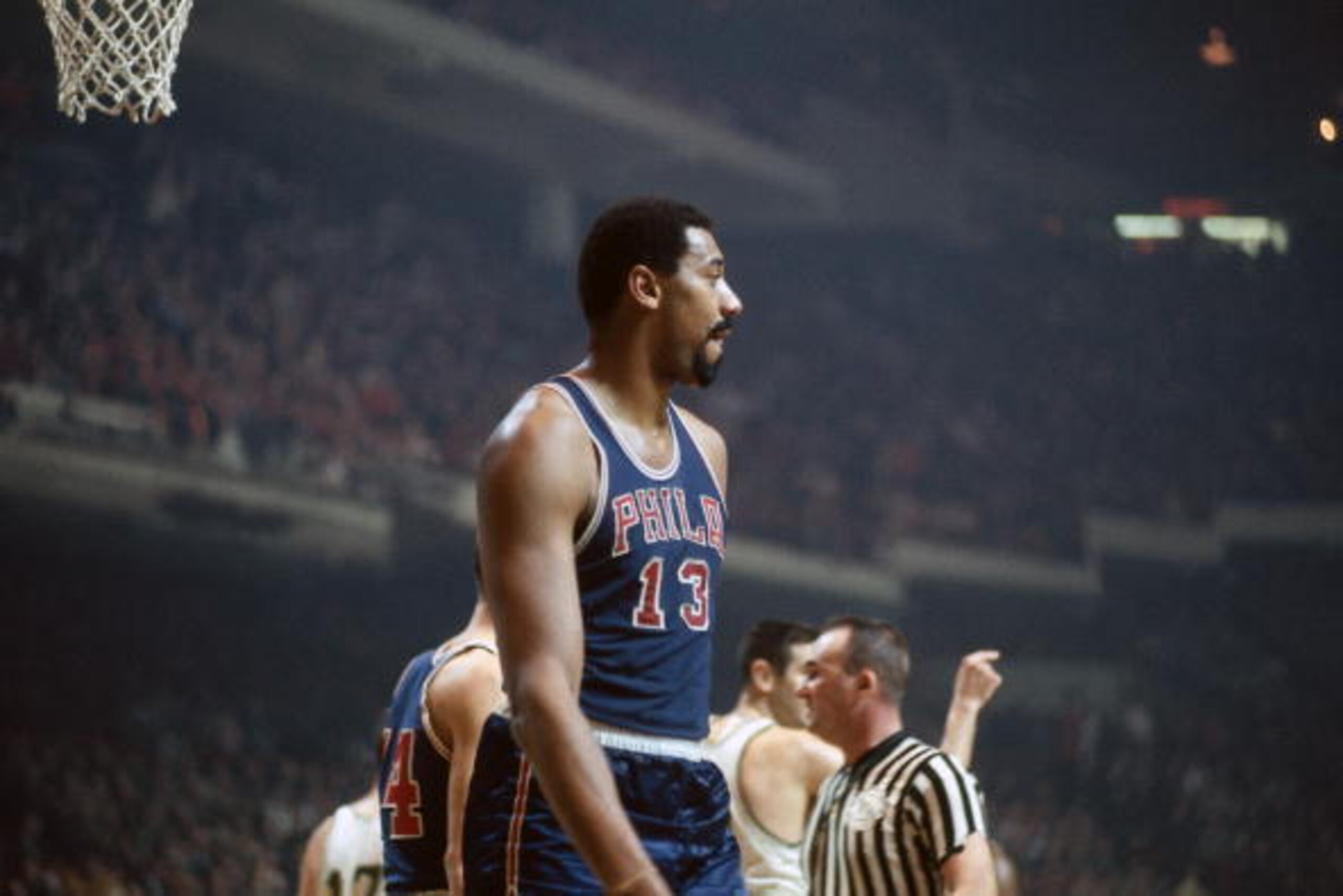 BOSTON - 1968:  Wilt Chamberlain #13 of the Philadelphia 76ers looks on against the Boston Celtics during a game played in 1968 at the Boston Garden in Boston, Massachusetts. NOTE TO USER: User expressly acknowledges and agrees that, by downloading and or
