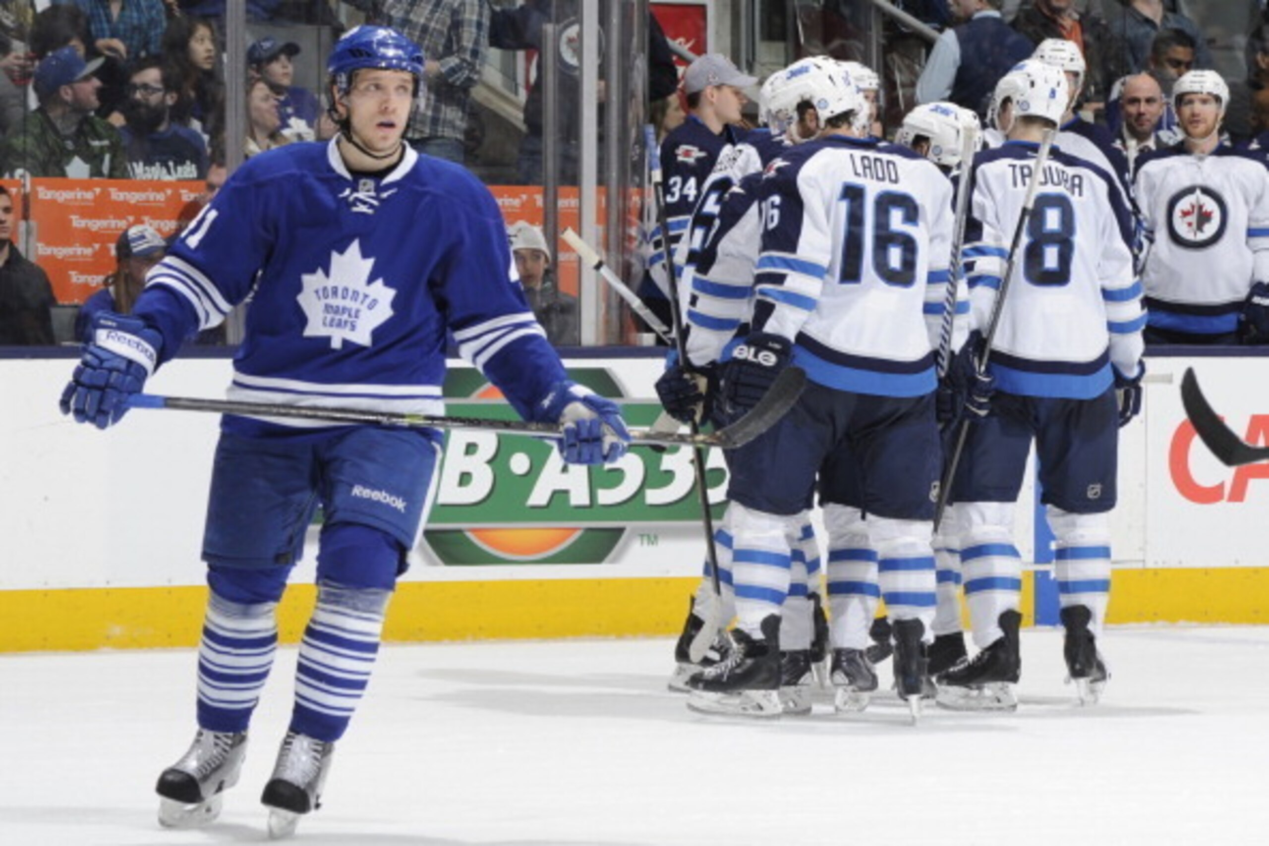 TORONTO, ON - APRIL 5:  Nikolai Kulemin #41 of the Toronto Maple Leafs looks on as Tobias Enstrom #39 of the Winnipeg Jets celebrates a second period goal with teammates during NHL game action April 5, 2014 at the Air Canada Centre in Toronto, Ontario, Ca