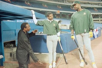 Parker, right, with A's teammate Dave Henderson and the Blue Jays' Lloyd Moseby in 1989.