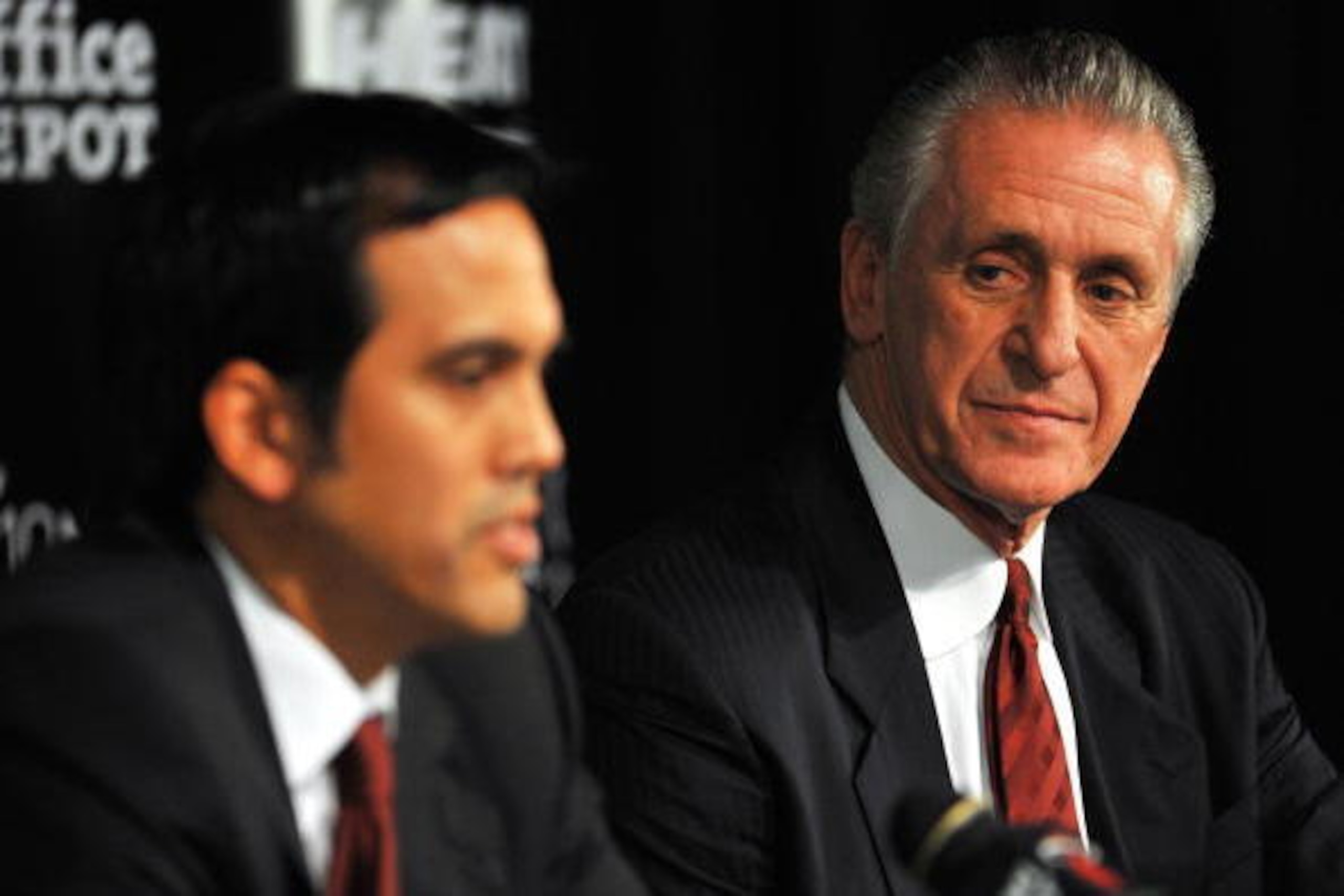MIAMI - JULY 09:  Head coach Erik Spoelstra (L) and President Pat Riley (R)  of the Miami Heat talk during a press conference after a welcome party for new teammates LeBron James, Dwyane Wade, and Chris Bosh at American Airlines Arena on July 9, 2010 in M