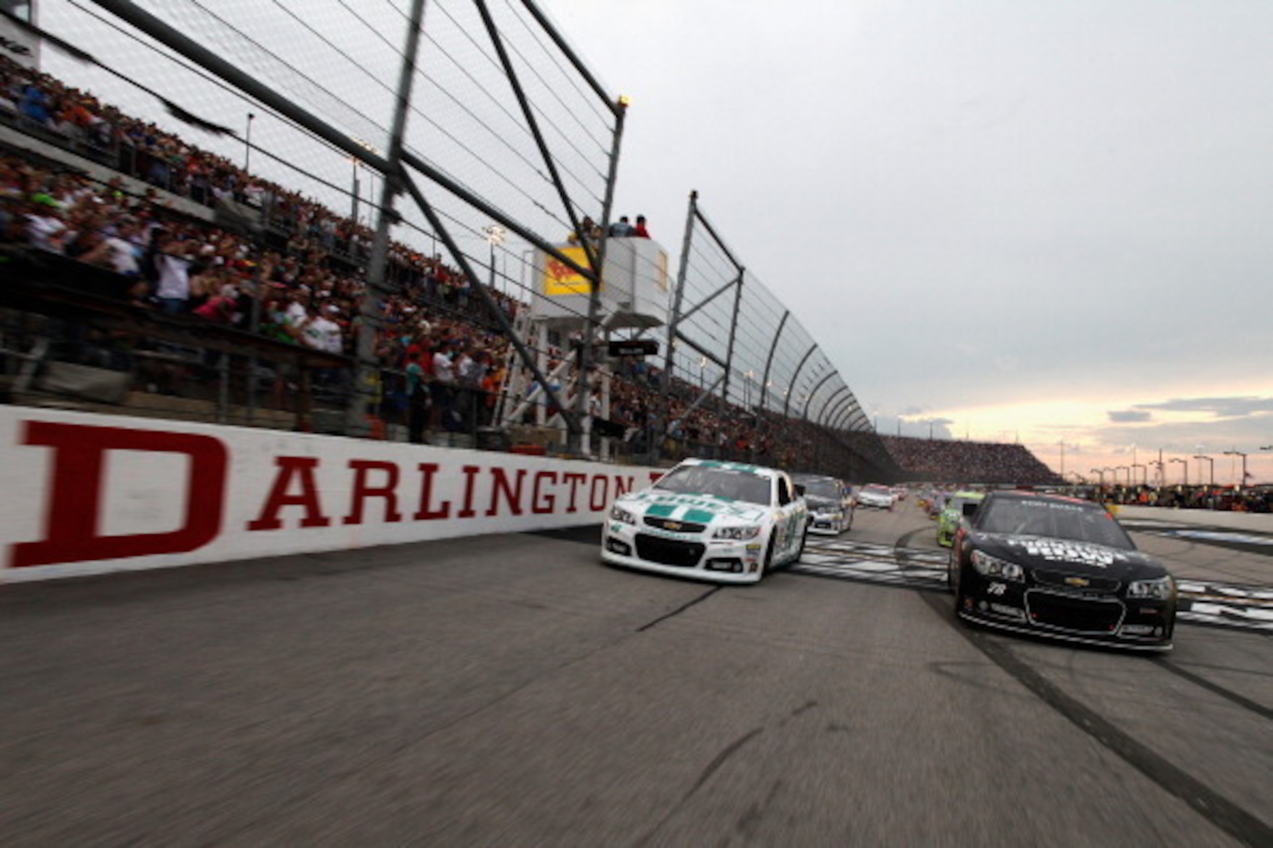 DARLINGTON, SC - MAY 11:  Kurt Busch, driver of the #78 Furniture Row Racing / Serta Chevrolet, and Jimmie Johnson, driver of the #48 Lowe's Emerald Green Chevrolet, lead the field before the start of the NASCAR Sprint Cup Series Bojangles' Southern 500 a