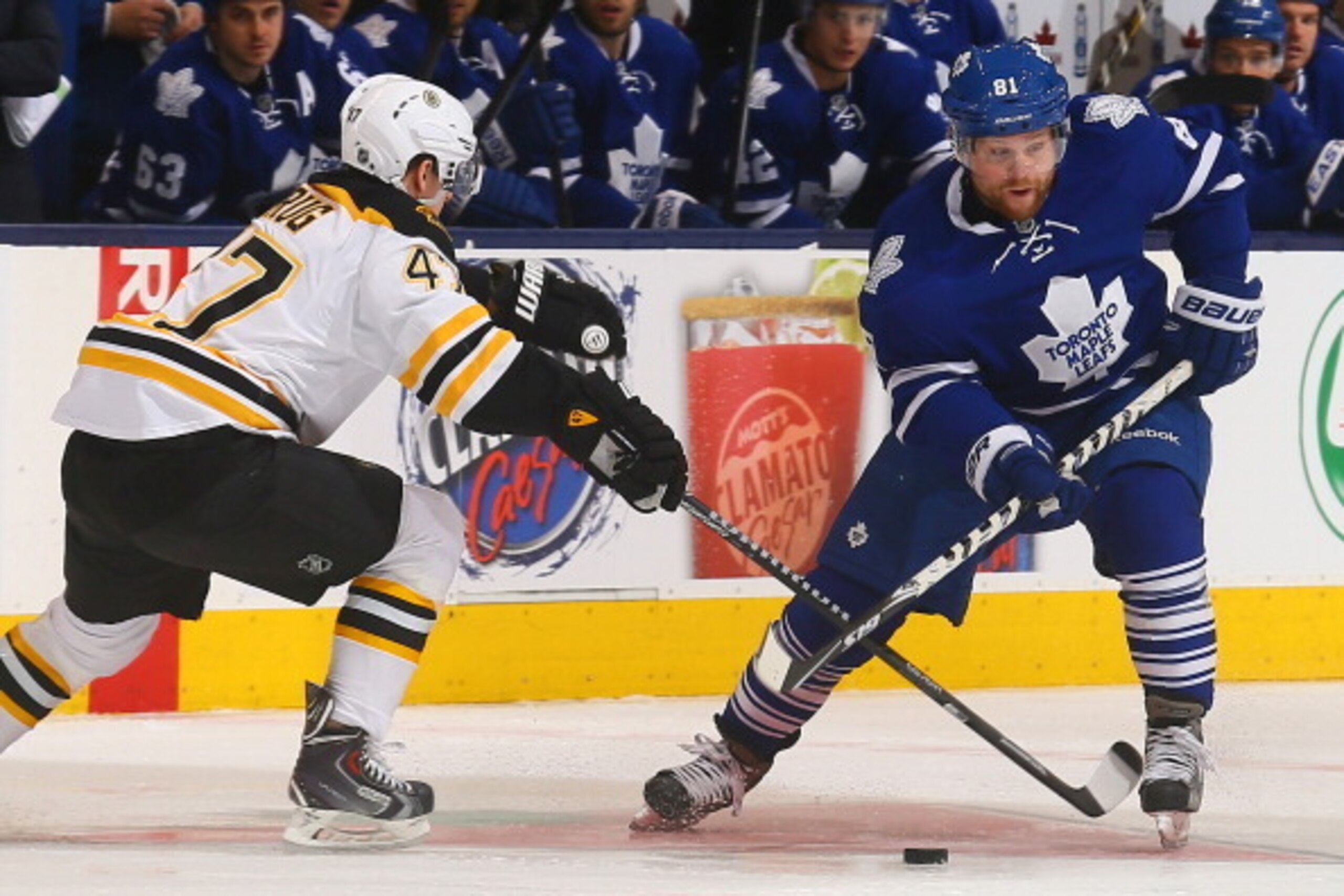TORONTO, ON - APRIL 3:  Phil Kessel #81 of the Toronto Maple Leafs skates the puck around Torey Krug #47 of the Boston Bruins during NHL action at the Air Canada Centre April 3, 2014 in Toronto, Ontario, Canada.  (Photo by Abelimages/Getty Images)